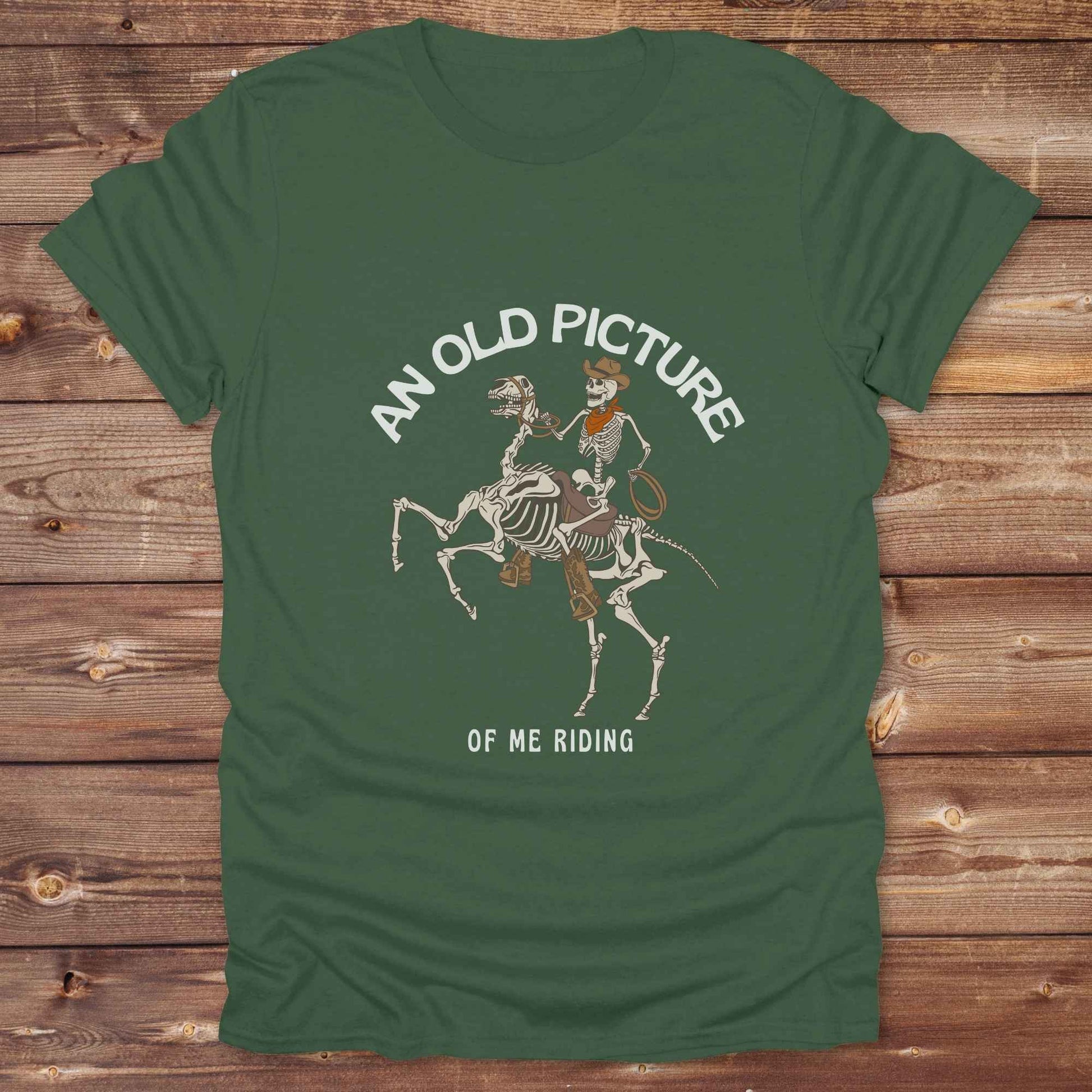 Saddle up with spooky western vibes in this skeleton cowboy “Old Picture of Me Riding” shirt, perfect for rodeo lovers and Halloween humor fans. This cowboy skeleton t-shirt combines retro western style with dark humor, ideal for ranchers, riders, and funny costume alternatives. Make fall fashion unforgettable with this witty, rustic western parody tee featuring bones, boots, and bold cowboy nostalgia.