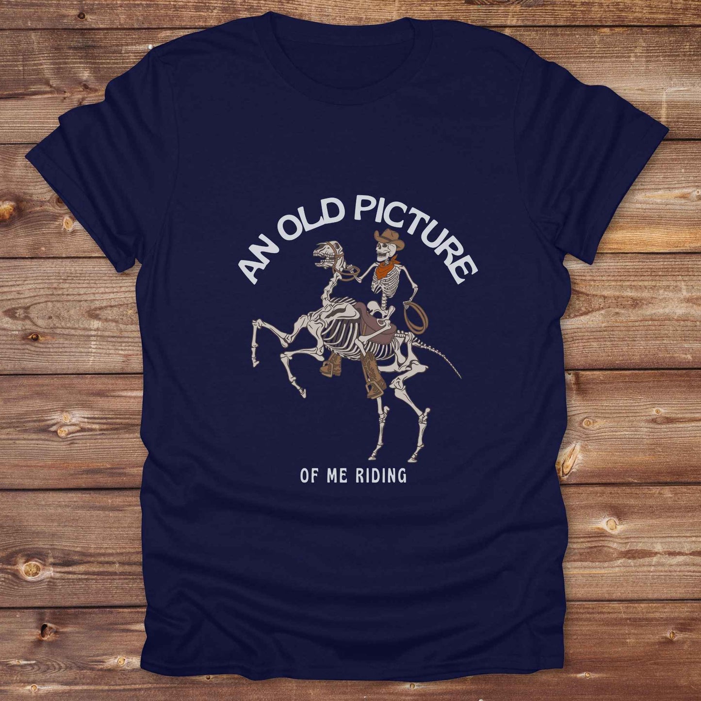 Saddle up with spooky western vibes in this skeleton cowboy “Old Picture of Me Riding” shirt, perfect for rodeo lovers and Halloween humor fans. This cowboy skeleton t-shirt combines retro western style with dark humor, ideal for ranchers, riders, and funny costume alternatives. Make fall fashion unforgettable with this witty, rustic western parody tee featuring bones, boots, and bold cowboy nostalgia.