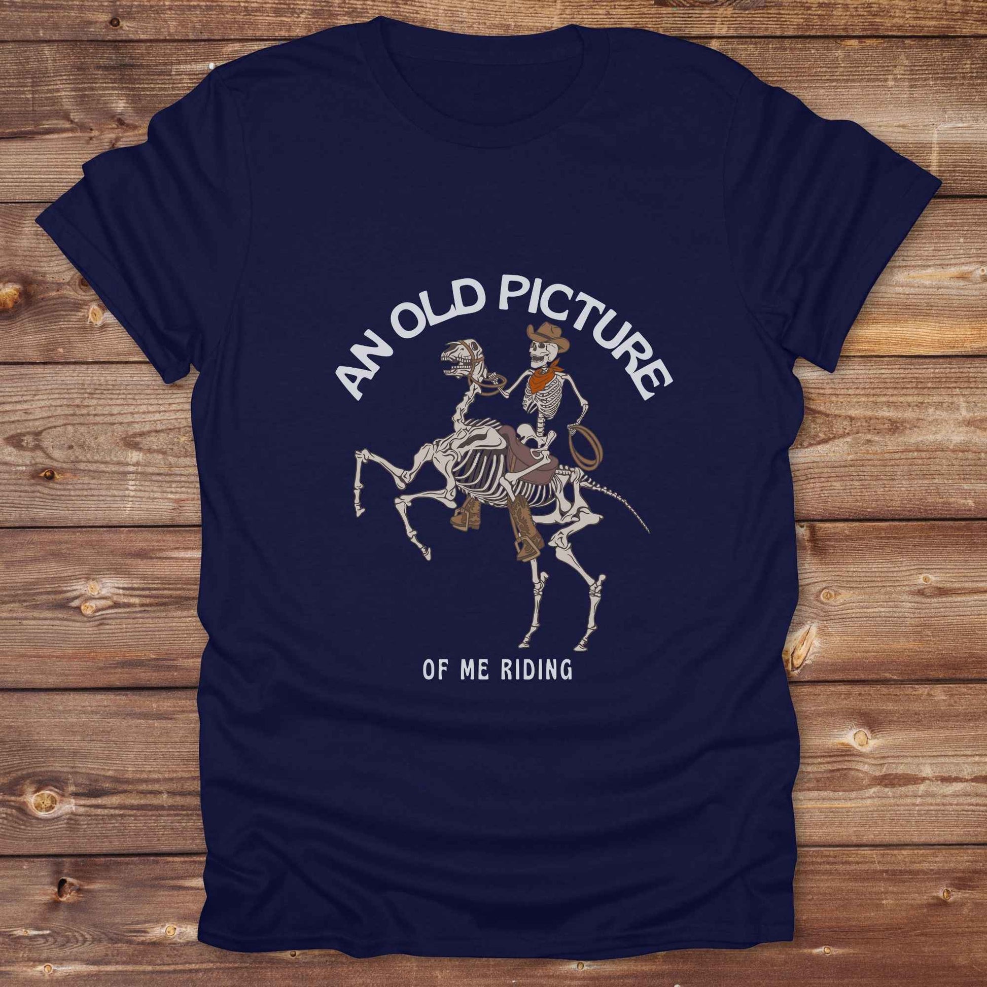 Saddle up with spooky western vibes in this skeleton cowboy “Old Picture of Me Riding” shirt, perfect for rodeo lovers and Halloween humor fans. This cowboy skeleton t-shirt combines retro western style with dark humor, ideal for ranchers, riders, and funny costume alternatives. Make fall fashion unforgettable with this witty, rustic western parody tee featuring bones, boots, and bold cowboy nostalgia.