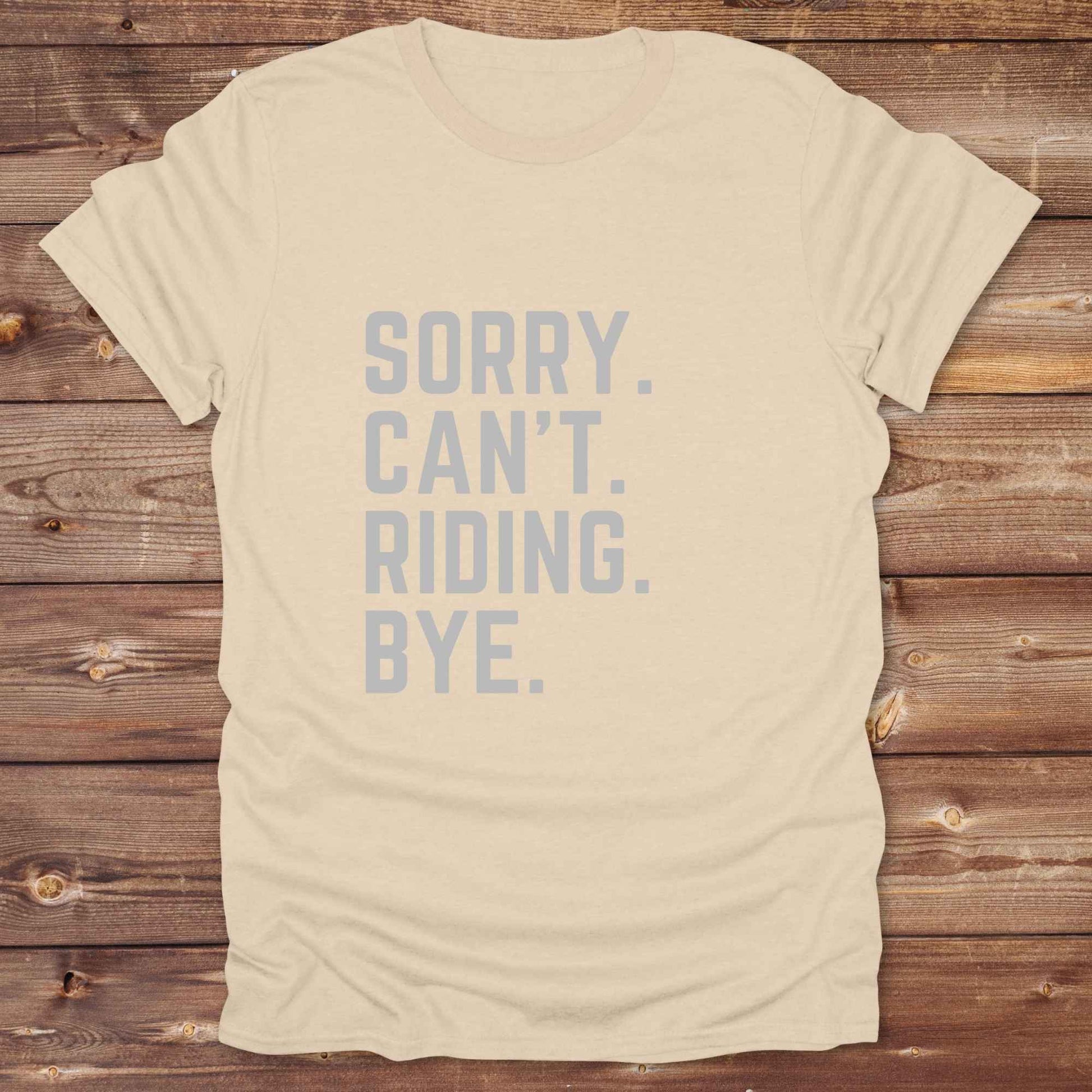 This “Sorry Can’t. Riding. Bye.” western typography tee is the perfect gift for horse lovers, trail riders, and anyone living the cowboy or cowgirl lifestyle. Made from premium Gildan 64000 cotton, it's unisex and available in 8 colors to match your cowboy core aesthetic. Whether you're off to a rodeo, riding horses, or just showing off your rustic humor, this bold minimalist horse quote shirt delivers personality and comfort. Great for birthdays, western lovers, and equestrian fashion fans.