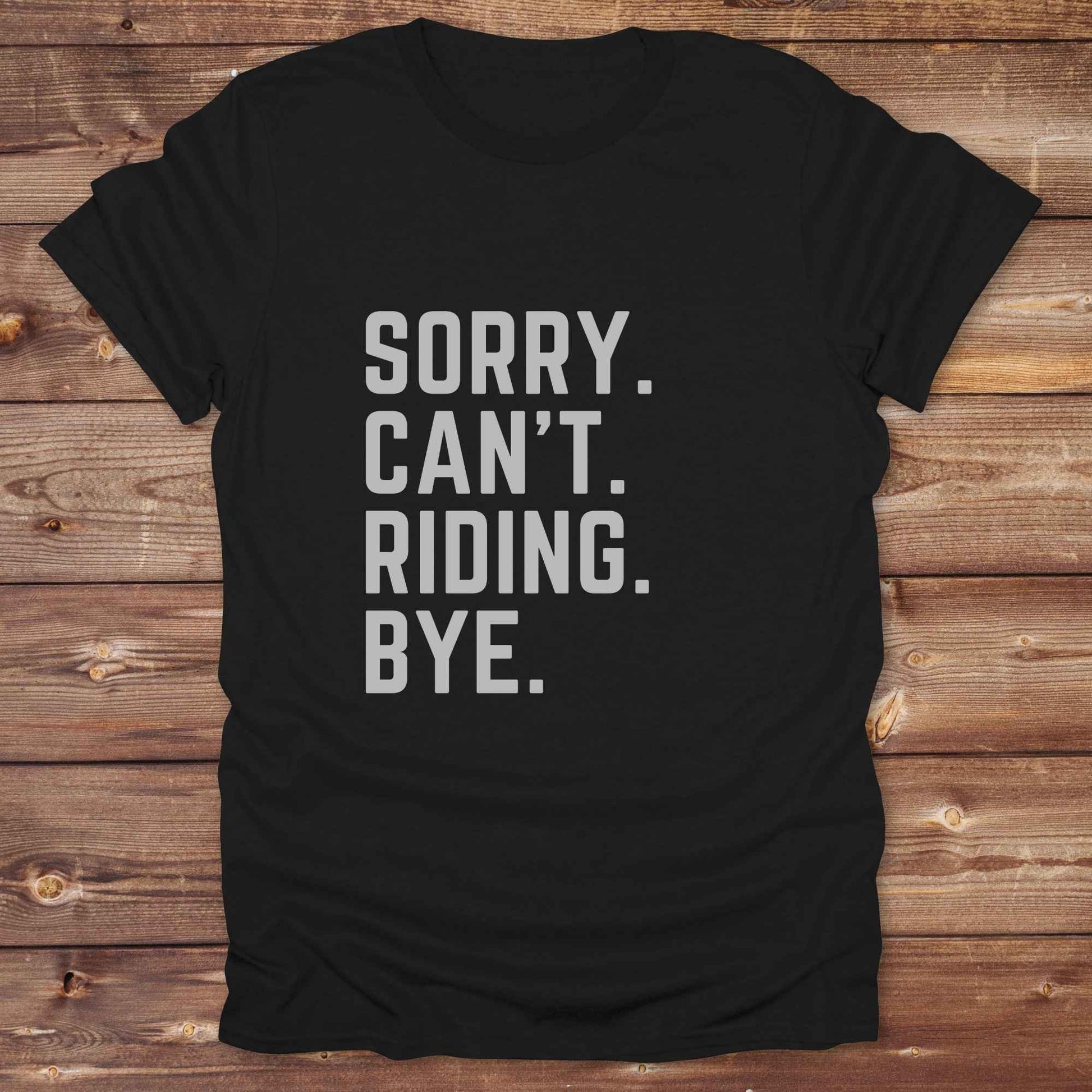 This “Sorry Can’t. Riding. Bye.” western typography tee is the perfect gift for horse lovers, trail riders, and anyone living the cowboy or cowgirl lifestyle. Made from premium Gildan 64000 cotton, it's unisex and available in 8 colors to match your cowboy core aesthetic. Whether you're off to a rodeo, riding horses, or just showing off your rustic humor, this bold minimalist horse quote shirt delivers personality and comfort. Great for birthdays, western lovers, and equestrian fashion fans.