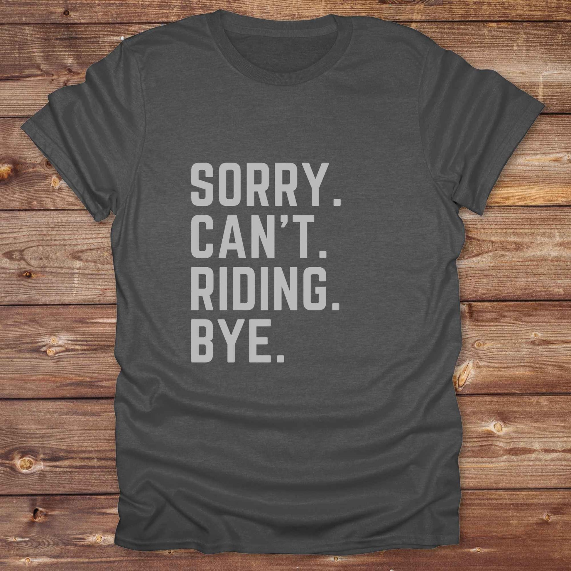 This “Sorry Can’t. Riding. Bye.” western typography tee is the perfect gift for horse lovers, trail riders, and anyone living the cowboy or cowgirl lifestyle. Made from premium Gildan 64000 cotton, it's unisex and available in 8 colors to match your cowboy core aesthetic. Whether you're off to a rodeo, riding horses, or just showing off your rustic humor, this bold minimalist horse quote shirt delivers personality and comfort. Great for birthdays, western lovers, and equestrian fashion fans.