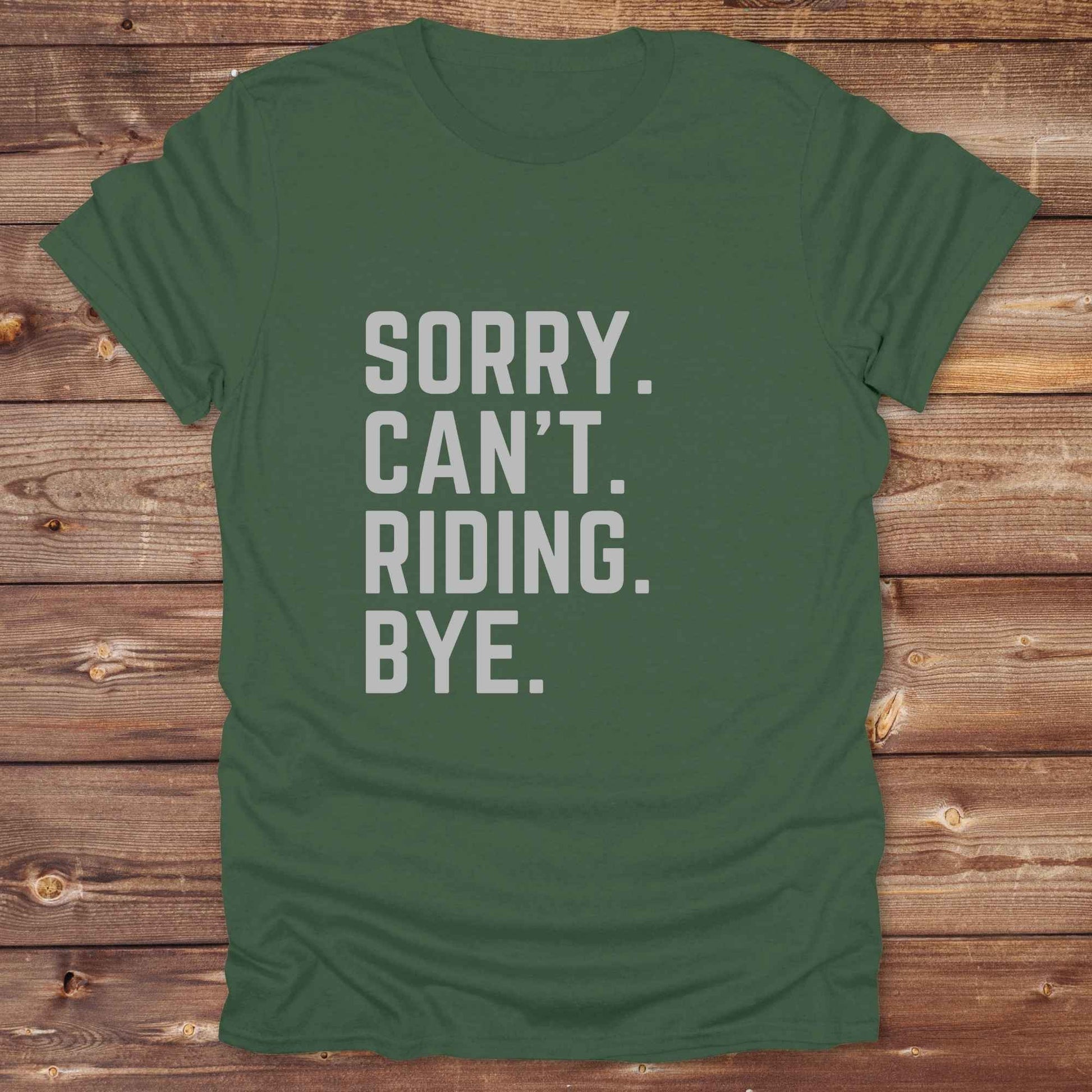This “Sorry Can’t. Riding. Bye.” western typography tee is the perfect gift for horse lovers, trail riders, and anyone living the cowboy or cowgirl lifestyle. Made from premium Gildan 64000 cotton, it's unisex and available in 8 colors to match your cowboy core aesthetic. Whether you're off to a rodeo, riding horses, or just showing off your rustic humor, this bold minimalist horse quote shirt delivers personality and comfort. Great for birthdays, western lovers, and equestrian fashion fans.