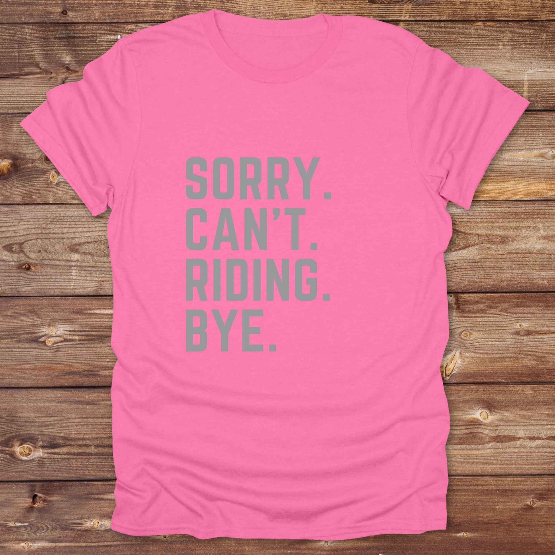 This “Sorry Can’t. Riding. Bye.” western typography tee is the perfect gift for horse lovers, trail riders, and anyone living the cowboy or cowgirl lifestyle. Made from premium Gildan 64000 cotton, it's unisex and available in 8 colors to match your cowboy core aesthetic. Whether you're off to a rodeo, riding horses, or just showing off your rustic humor, this bold minimalist horse quote shirt delivers personality and comfort. Great for birthdays, western lovers, and equestrian fashion fans.