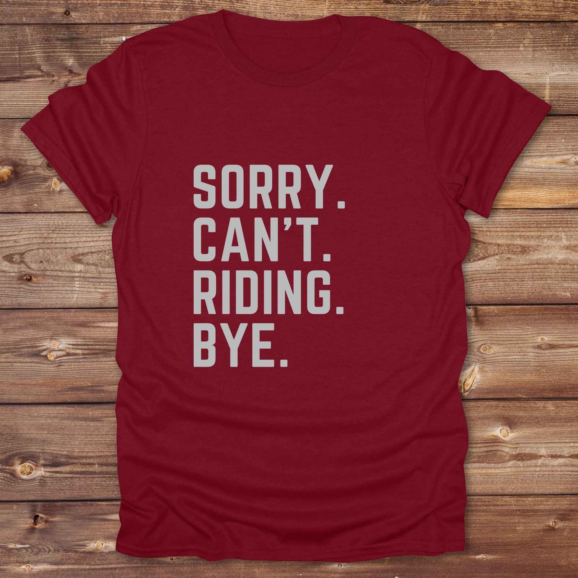 This “Sorry Can’t. Riding. Bye.” western typography tee is the perfect gift for horse lovers, trail riders, and anyone living the cowboy or cowgirl lifestyle. Made from premium Gildan 64000 cotton, it's unisex and available in 8 colors to match your cowboy core aesthetic. Whether you're off to a rodeo, riding horses, or just showing off your rustic humor, this bold minimalist horse quote shirt delivers personality and comfort. Great for birthdays, western lovers, and equestrian fashion fans.