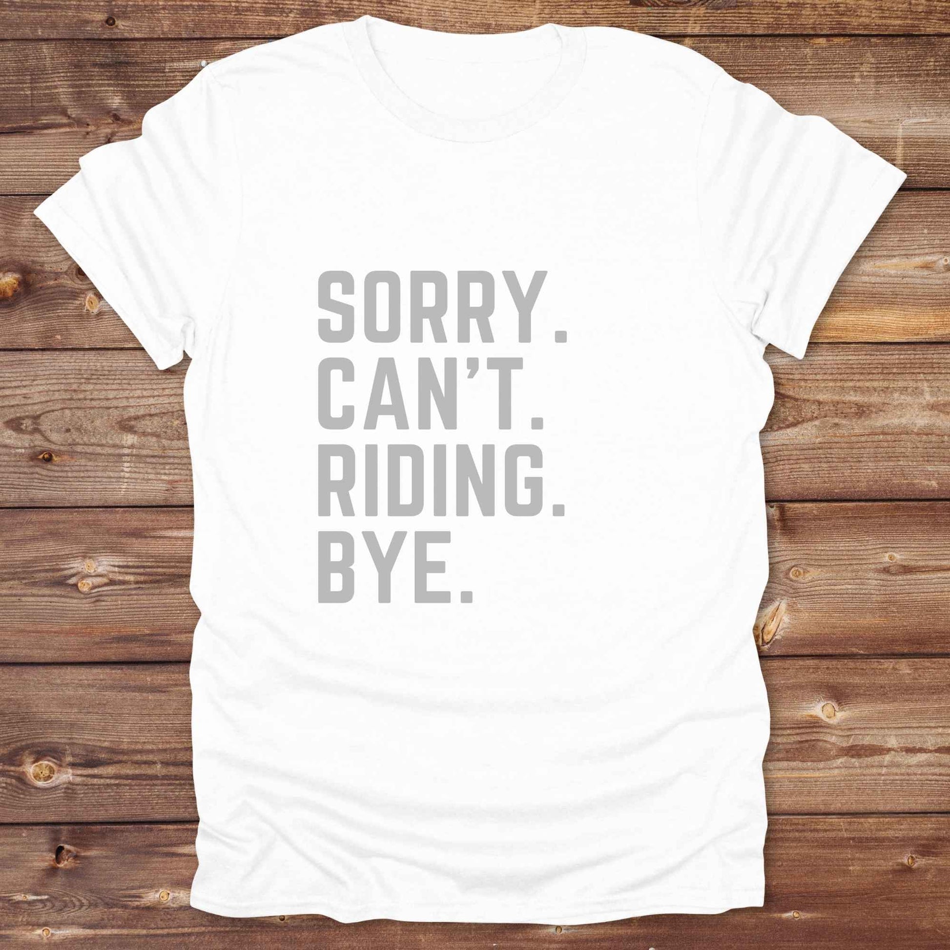 This “Sorry Can’t. Riding. Bye.” western typography tee is the perfect gift for horse lovers, trail riders, and anyone living the cowboy or cowgirl lifestyle. Made from premium Gildan 64000 cotton, it's unisex and available in 8 colors to match your cowboy core aesthetic. Whether you're off to a rodeo, riding horses, or just showing off your rustic humor, this bold minimalist horse quote shirt delivers personality and comfort. Great for birthdays, western lovers, and equestrian fashion fans.