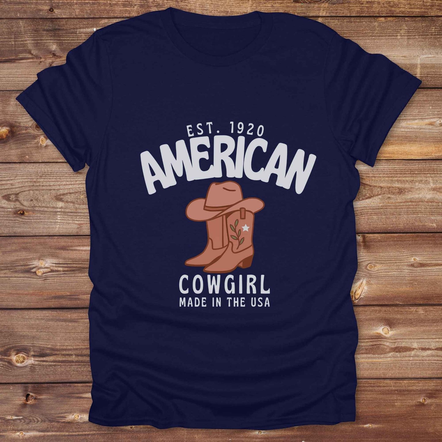 This American Cowgirl T-Shirt is the perfect mix of bold western pride and boho rodeo style. Featuring a rustic boot and hat graphic, it's made for country girls who live for rodeo season and horse rides. It’s a statement piece for cowgirls, country lovers, and western fashion fans alike. Whether you’re gifting it for a birthday or styling it for your next state fair, this tee brings serious cowboy core energy to your closet. A must have for horse lovers.