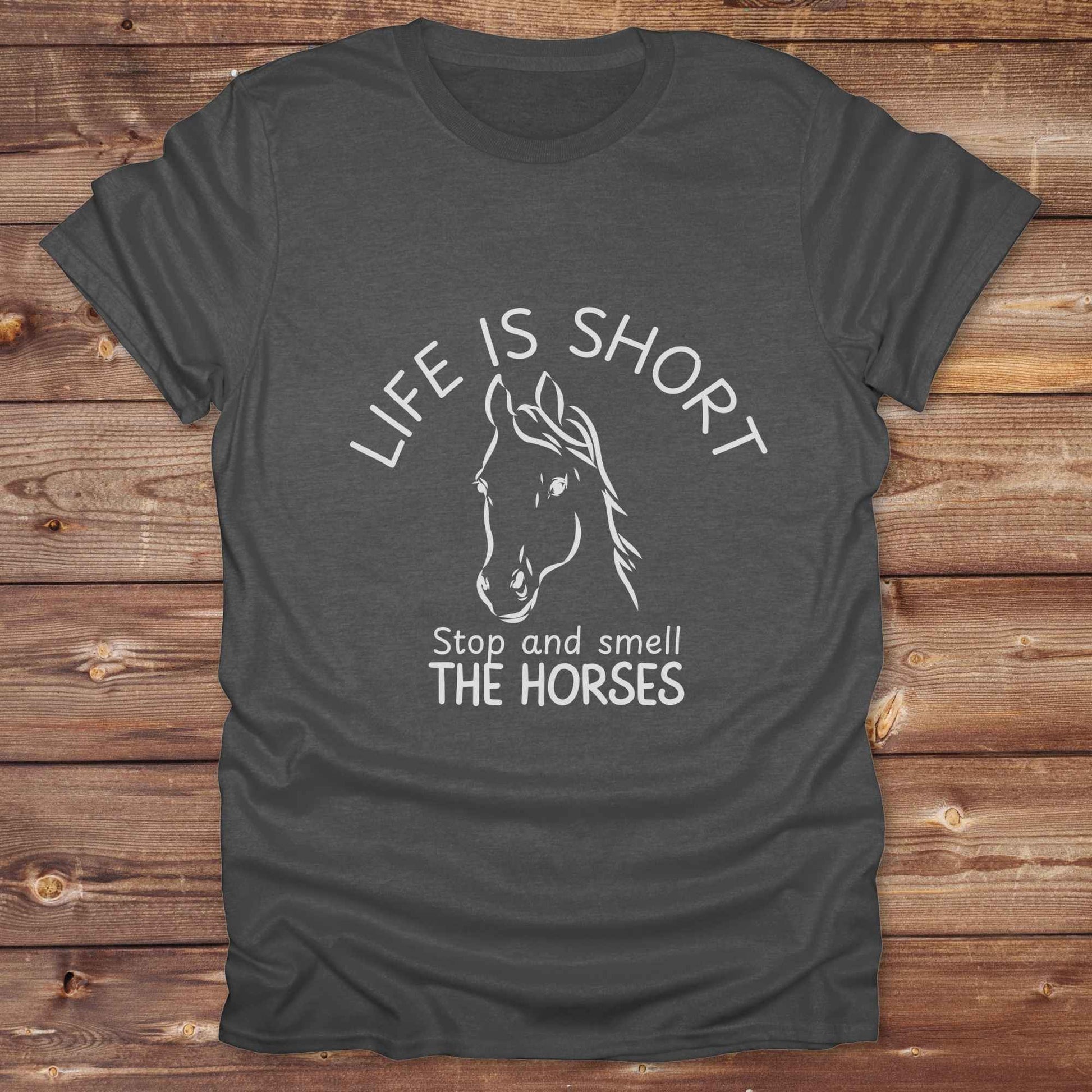 Life is short stop and smell the horses tee. perfect for rodeo fans, horse moms, country girls, and anyone who embraces equestrian life. Whether you're mucking stalls, trail riding, or hitting the local country fair, this rustic shirt makes a fun and relatable statement. It’s the ideal gift for birthdays, holidays, or spontaneous barn day laughs.