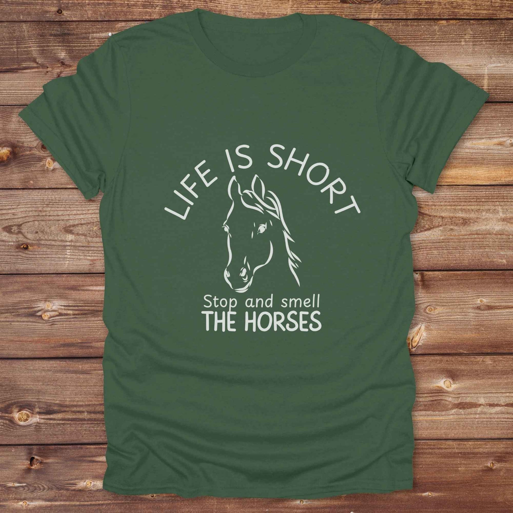 Life is short stop and smell the horses tee. perfect for rodeo fans, horse moms, country girls, and anyone who embraces equestrian life. Whether you're mucking stalls, trail riding, or hitting the local country fair, this rustic shirt makes a fun and relatable statement. It’s the ideal gift for birthdays, holidays, or spontaneous barn day laughs.