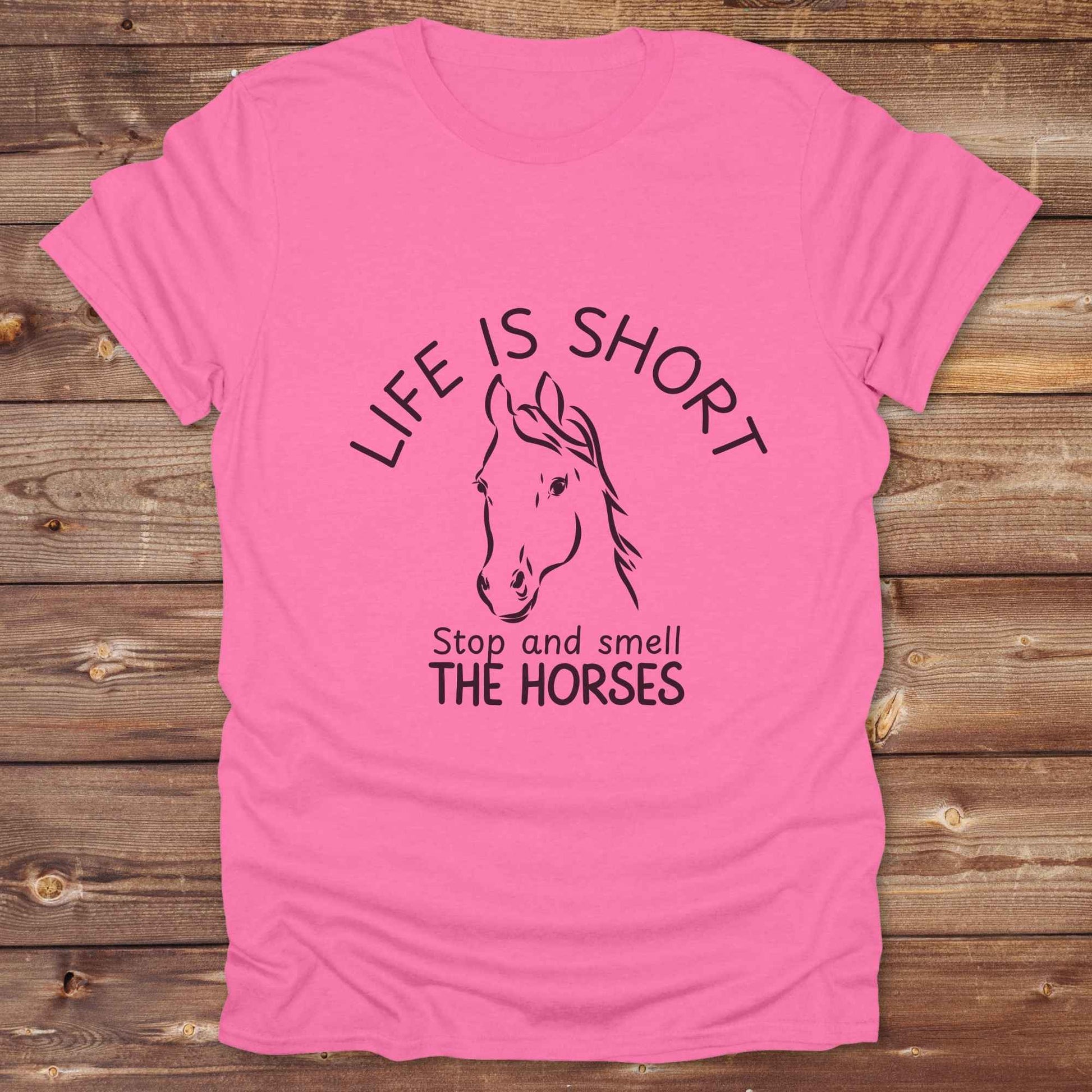 Life is short stop and smell the horses tee. perfect for rodeo fans, horse moms, country girls, and anyone who embraces equestrian life. Whether you're mucking stalls, trail riding, or hitting the local country fair, this rustic shirt makes a fun and relatable statement. It’s the ideal gift for birthdays, holidays, or spontaneous barn day laughs.