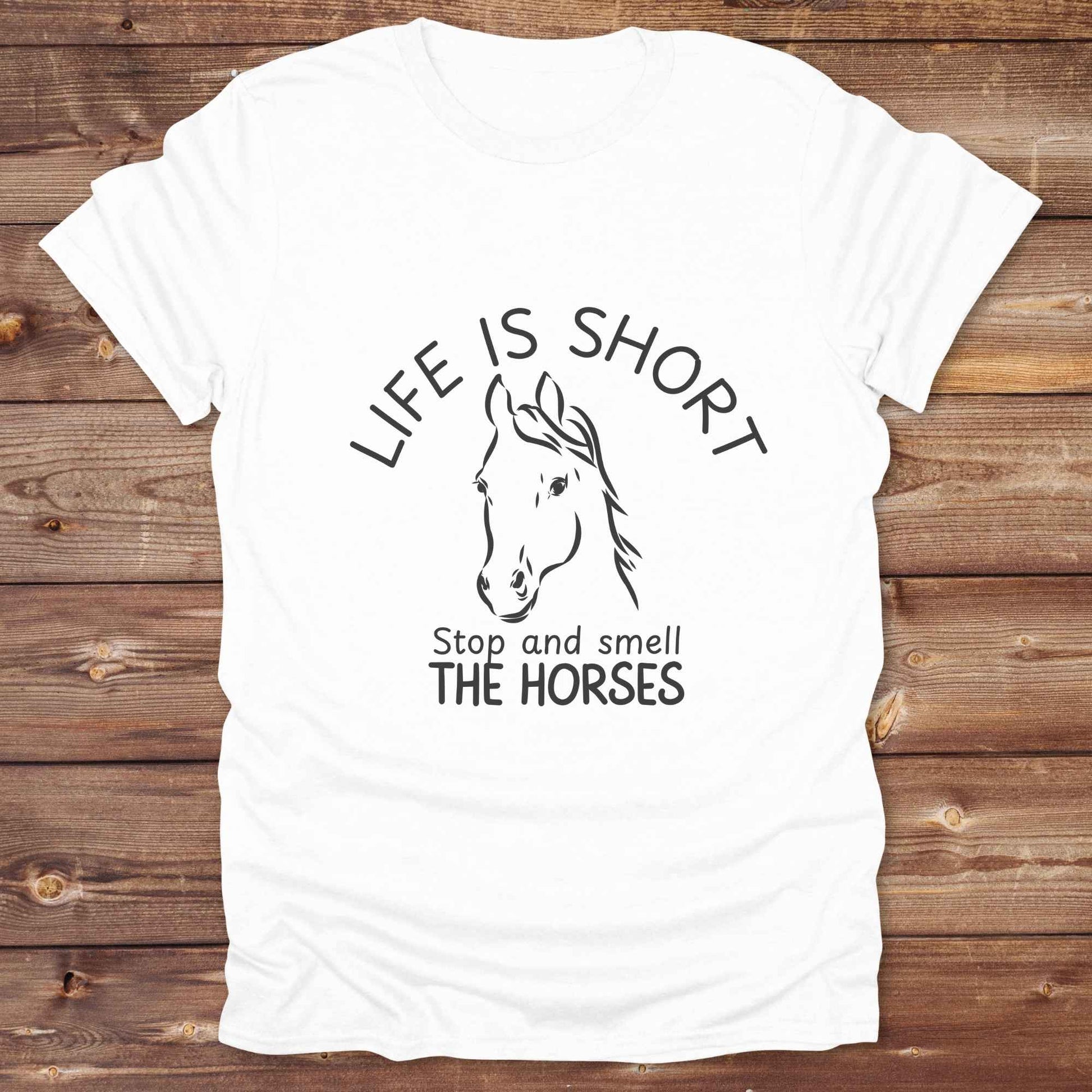 Life is short stop and smell the horses tee. perfect for rodeo fans, horse moms, country girls, and anyone who embraces equestrian life. Whether you're mucking stalls, trail riding, or hitting the local country fair, this rustic shirt makes a fun and relatable statement. It’s the ideal gift for birthdays, holidays, or spontaneous barn day laughs.
