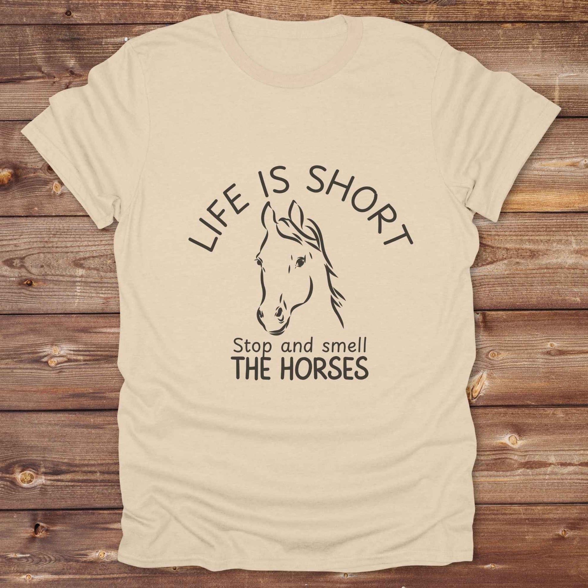 Life is short stop and smell the horses tee. perfect for rodeo fans, horse moms, country girls, and anyone who embraces equestrian life. Whether you're mucking stalls, trail riding, or hitting the local country fair, this rustic shirt makes a fun and relatable statement. It’s the ideal gift for birthdays, holidays, or spontaneous barn day laughs.