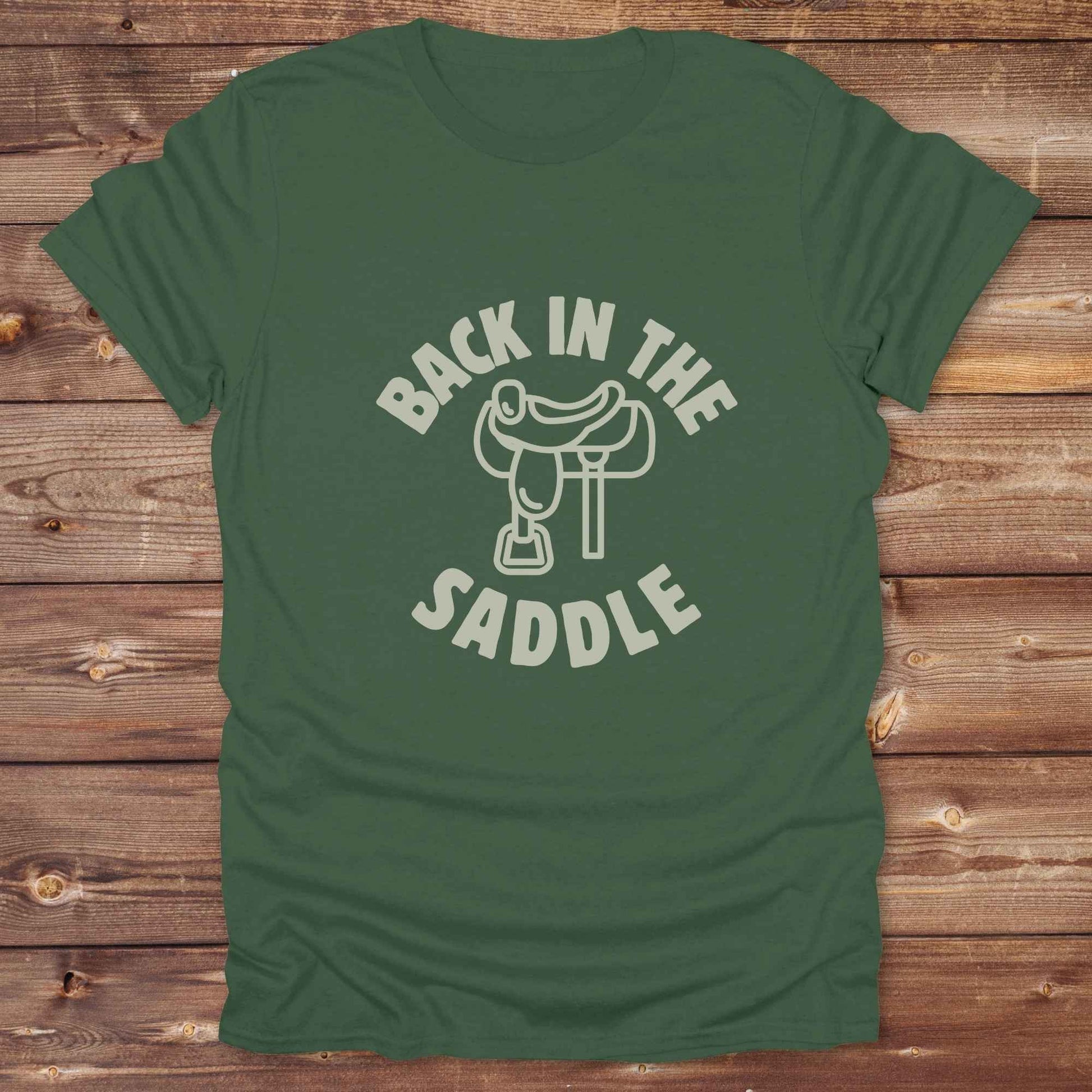 Our "Back in the Saddle" t-shirt is the perfect western-style graphic tee for cowboys and cowgirls who love horseback riding, rodeo culture, and rustic country fashion. Featuring a clean saddle illustration and retro western typography, this shirt blends comfort and character, making it ideal for ranch wear, horse lovers, and rodeo enthusiasts. Whether you're heading to a country concert, festival, or barn, this tee stands out. Makes a great gift for horse riders, western fans or anyone getting back riding