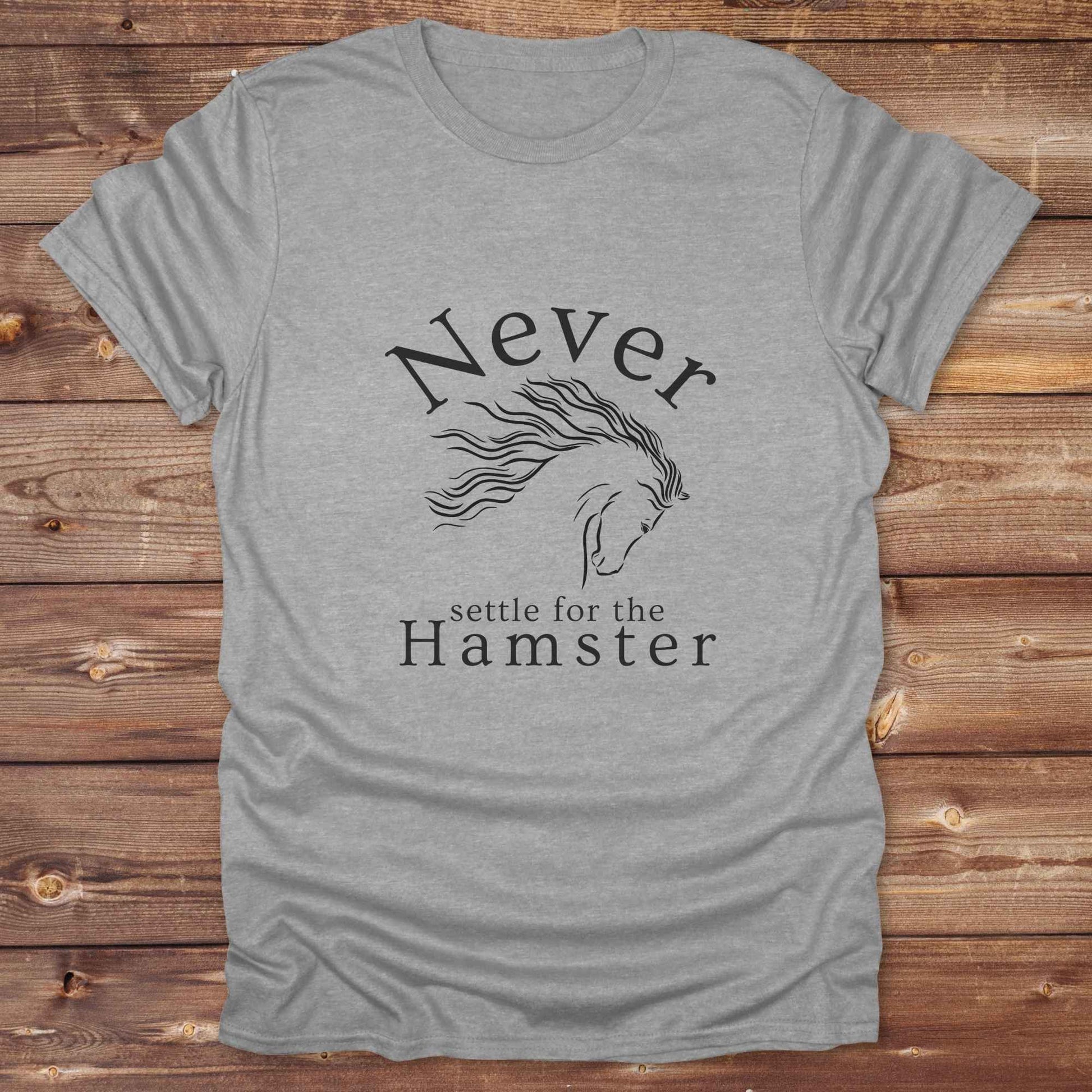 "Never Settle for the Hamster" T-shirt a funny and empowering western tee designed for horse lovers, cowgirls, and cowboy humor fans. Bold typography and flowing horse graphic, perfect for rodeo events, country fairs, or everyday ranch life. Whether you're buying for yourself or gifting to a wild-hearted horse girl, this shirt makes a statement that’s as fierce as your spirit.