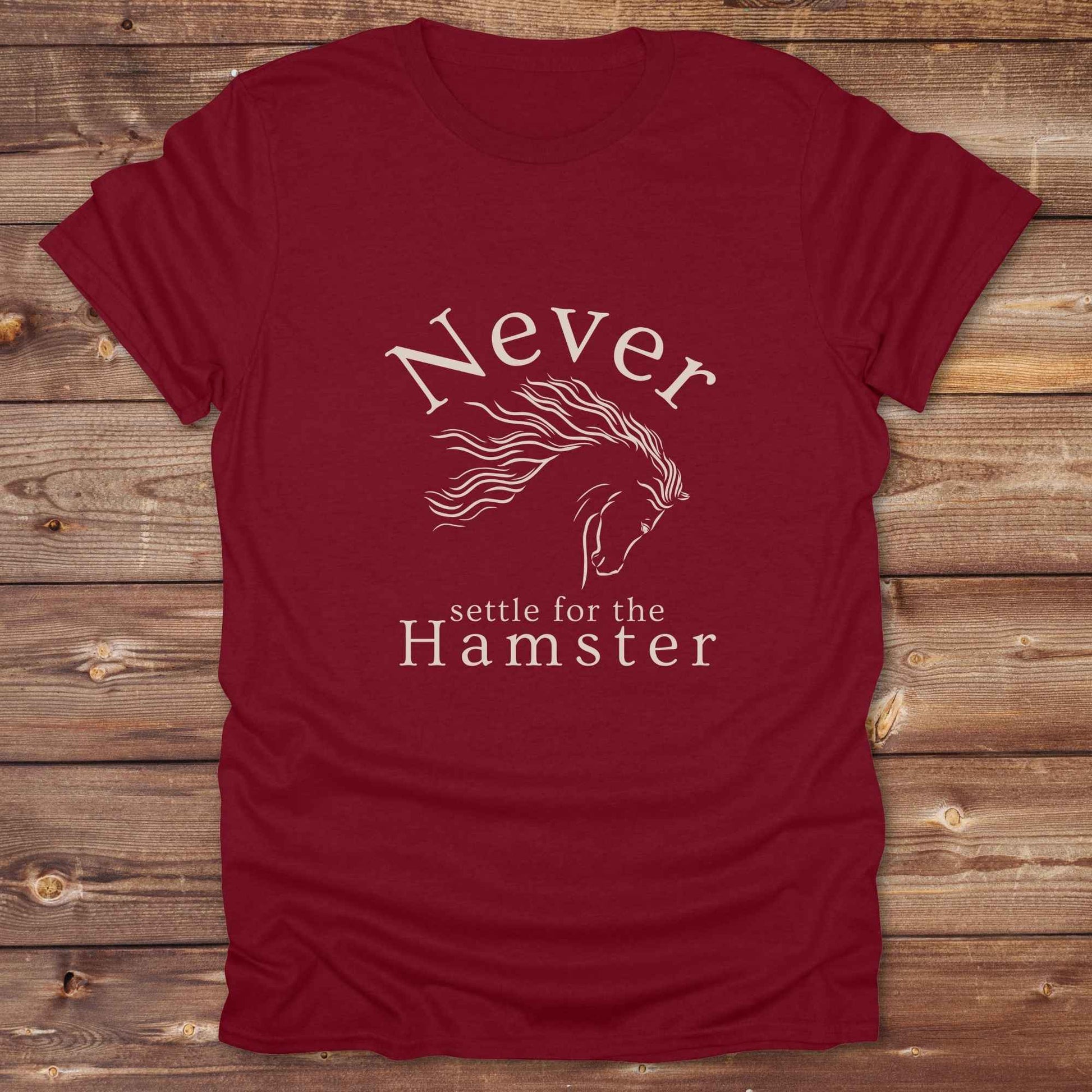 "Never Settle for the Hamster" T-shirt a funny and empowering western tee designed for horse lovers, cowgirls, and cowboy humor fans. Bold typography and flowing horse graphic, perfect for rodeo events, country fairs, or everyday ranch life. Whether you're buying for yourself or gifting to a wild-hearted horse girl, this shirt makes a statement that’s as fierce as your spirit.