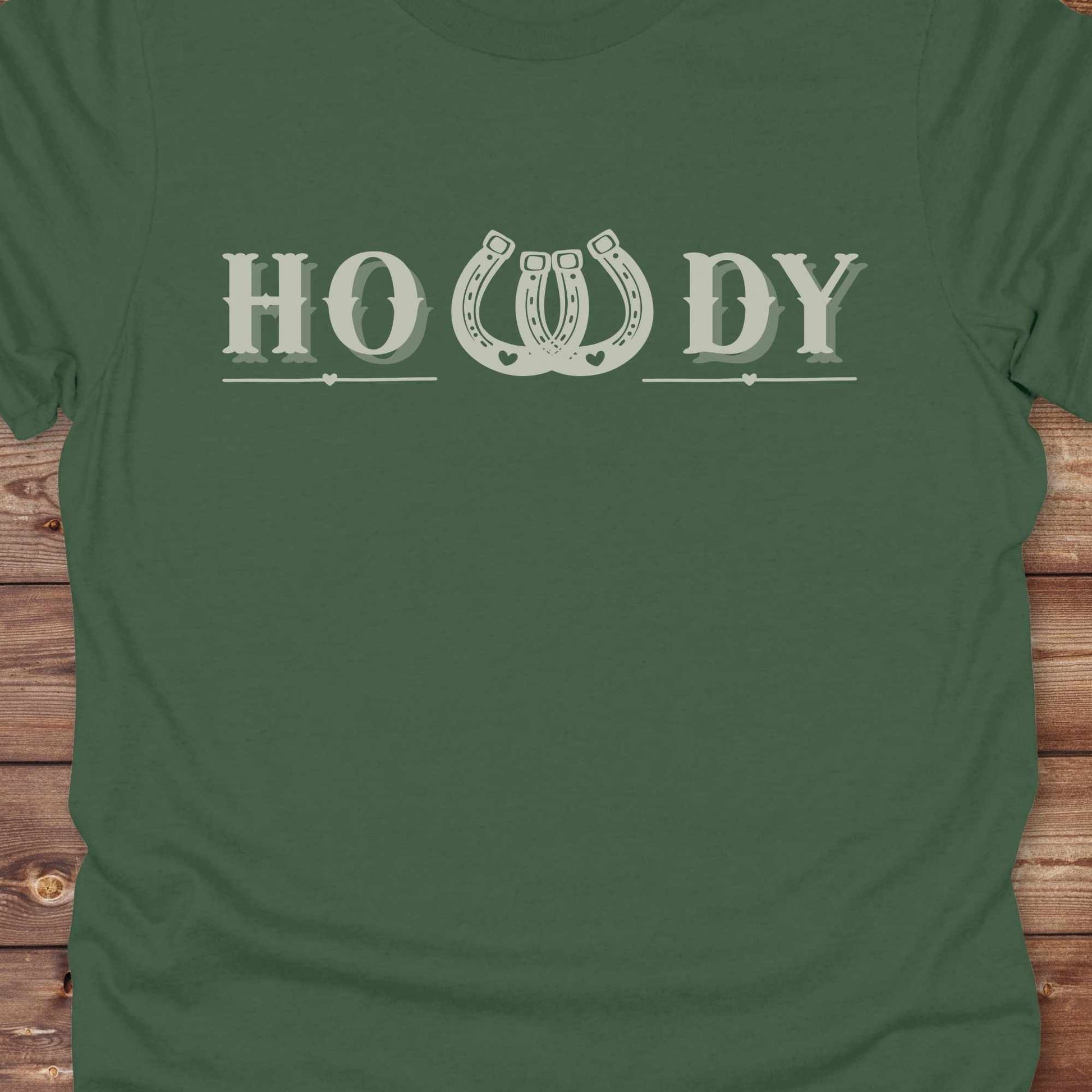 Say “Howdy” in true western style with this rustic horseshoe tee designed for cowboys, cowgirls, and horse lovers alike. Featuring a bold western font and a double horseshoe “W,” this shirt blends southern charm with modern rodeo flair. It's perfect for birthdays, rodeo weekends, country fairs, or just everyday ranch life. Whether you're a rancher, rider, or rural rebel, this shirt adds a little yeehaw to your wardrobe.