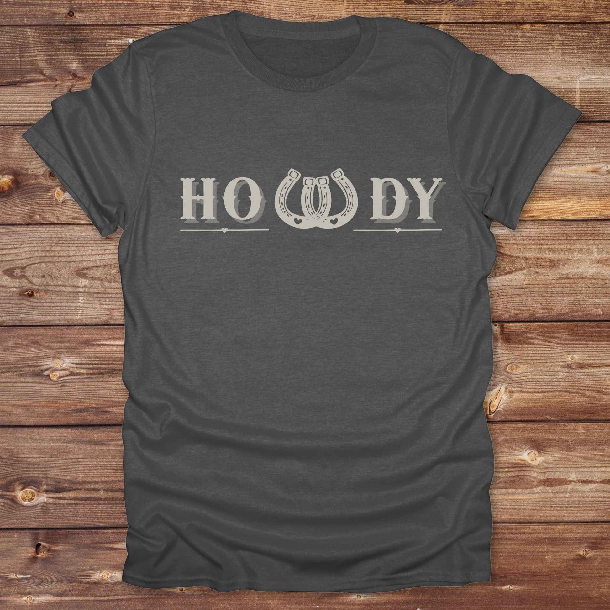 Say “Howdy” in true western style with this rustic horseshoe tee designed for cowboys, cowgirls, and horse lovers alike. Featuring a bold western font and a double horseshoe “W,” this shirt blends southern charm with modern rodeo flair. It's perfect for birthdays, rodeo weekends, country fairs, or just everyday ranch life. Whether you're a rancher, rider, or rural rebel, this shirt adds a little yeehaw to your wardrobe.