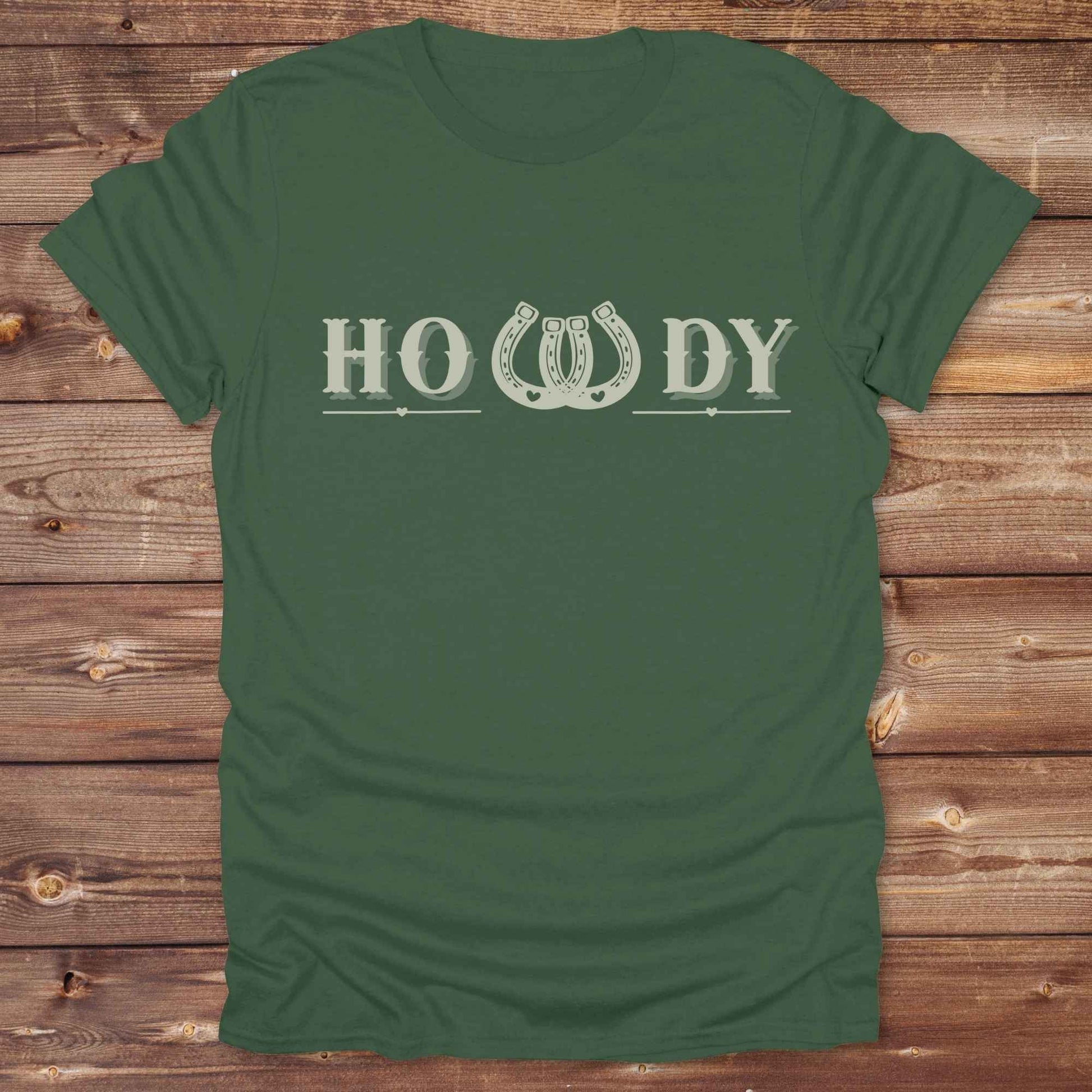 Say “Howdy” in true western style with this rustic horseshoe tee designed for cowboys, cowgirls, and horse lovers alike. Featuring a bold western font and a double horseshoe “W,” this shirt blends southern charm with modern rodeo flair. It's perfect for birthdays, rodeo weekends, country fairs, or just everyday ranch life. Whether you're a rancher, rider, or rural rebel, this shirt adds a little yeehaw to your wardrobe.
