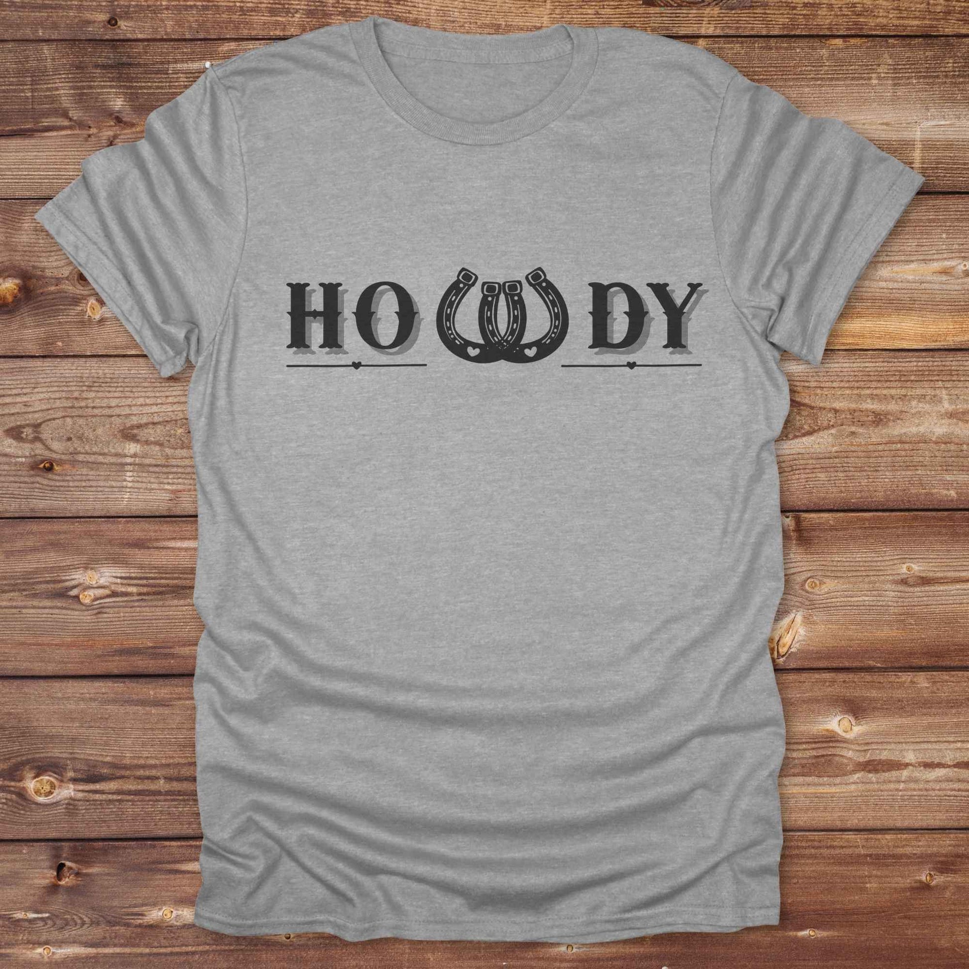 Say “Howdy” in true western style with this rustic horseshoe tee designed for cowboys, cowgirls, and horse lovers alike. Featuring a bold western font and a double horseshoe “W,” this shirt blends southern charm with modern rodeo flair. It's perfect for birthdays, rodeo weekends, country fairs, or just everyday ranch life. Whether you're a rancher, rider, or rural rebel, this shirt adds a little yeehaw to your wardrobe.
