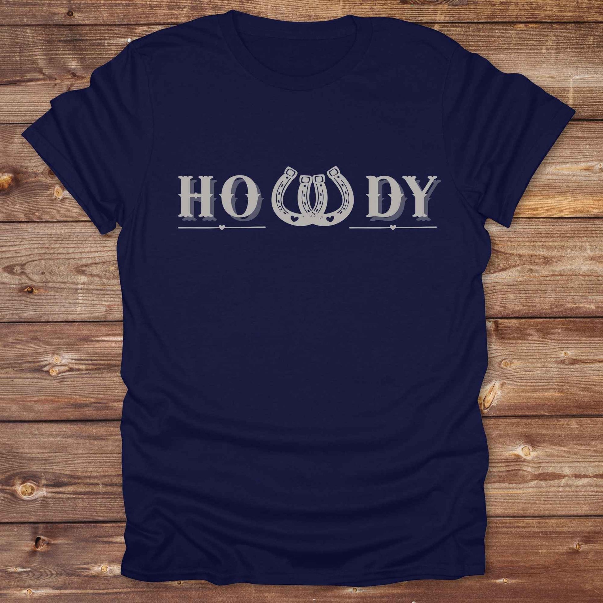 Say “Howdy” in true western style with this rustic horseshoe tee designed for cowboys, cowgirls, and horse lovers alike. Featuring a bold western font and a double horseshoe “W,” this shirt blends southern charm with modern rodeo flair. It's perfect for birthdays, rodeo weekends, country fairs, or just everyday ranch life. Whether you're a rancher, rider, or rural rebel, this shirt adds a little yeehaw to your wardrobe.
