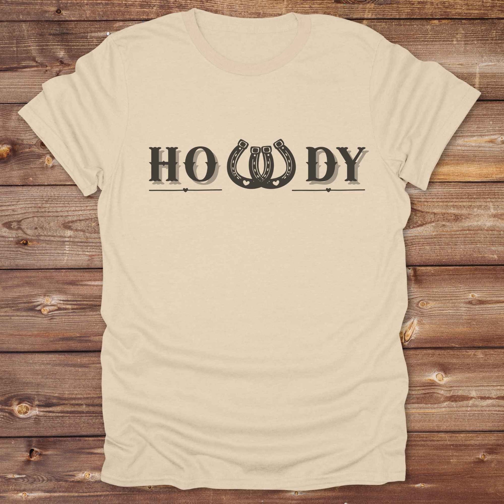 Say “Howdy” in true western style with this rustic horseshoe tee designed for cowboys, cowgirls, and horse lovers alike. Featuring a bold western font and a double horseshoe “W,” this shirt blends southern charm with modern rodeo flair. It's perfect for birthdays, rodeo weekends, country fairs, or just everyday ranch life. Whether you're a rancher, rider, or rural rebel, this shirt adds a little yeehaw to your wardrobe.