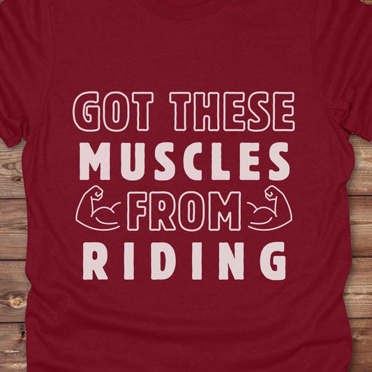 “Got These Muscles from Riding” western t-shirt is perfect for cowgirls, cowboys, horse lovers, and rodeo fans who live strong without stepping in a gym. Designed for equestrians and rural riders who know their strength comes from the saddle, this funny and bold graphic tee is a conversation starter at any barn, rodeo, or Western event. Makes a great gift for horseback riders, trainers, or country girls who work hard and flex harder.