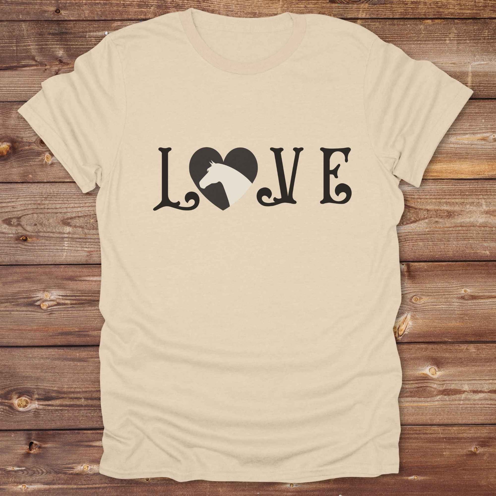 This Love Horses T-Shirt is the perfect expression of passion for horse lovers and cowgirls alike. With a unique heart-and-horse silhouette design and rustic western typography, it makes a thoughtful gift for birthdays, rodeo lovers, equestrians, and country women who live the cowboy lifestyle. The tee pairs well with denim, boots, and a bold cowgirl spirit. Whether for barn days, trail rides, or everyday western fashion, this shirt belongs in your rodeo ready wardrobe.