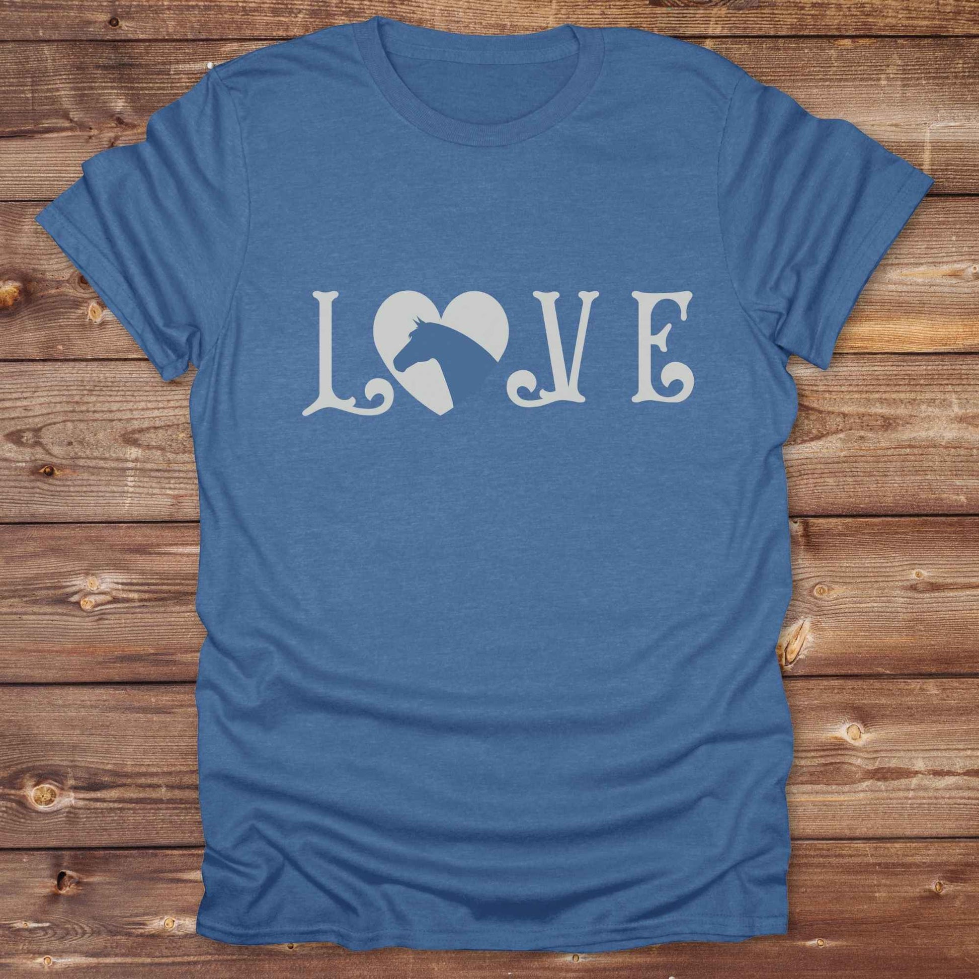 This Love Horses T-Shirt is the perfect expression of passion for horse lovers and cowgirls alike. With a unique heart-and-horse silhouette design and rustic western typography, it makes a thoughtful gift for birthdays, rodeo lovers, equestrians, and country women who live the cowboy lifestyle. The tee pairs well with denim, boots, and a bold cowgirl spirit. Whether for barn days, trail rides, or everyday western fashion, this shirt belongs in your rodeo ready wardrobe.