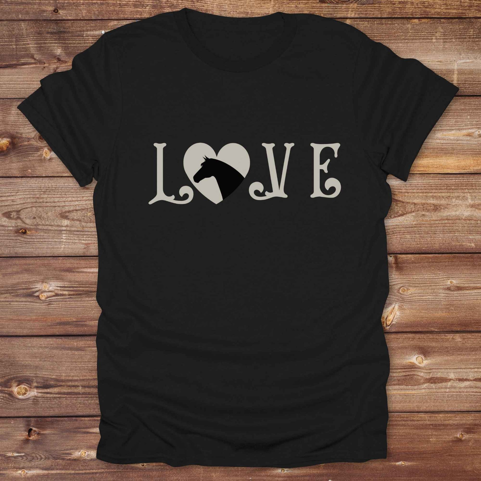 This Love Horses T-Shirt is the perfect expression of passion for horse lovers and cowgirls alike. With a unique heart-and-horse silhouette design and rustic western typography, it makes a thoughtful gift for birthdays, rodeo lovers, equestrians, and country women who live the cowboy lifestyle. The tee pairs well with denim, boots, and a bold cowgirl spirit. Whether for barn days, trail rides, or everyday western fashion, this shirt belongs in your rodeo ready wardrobe.