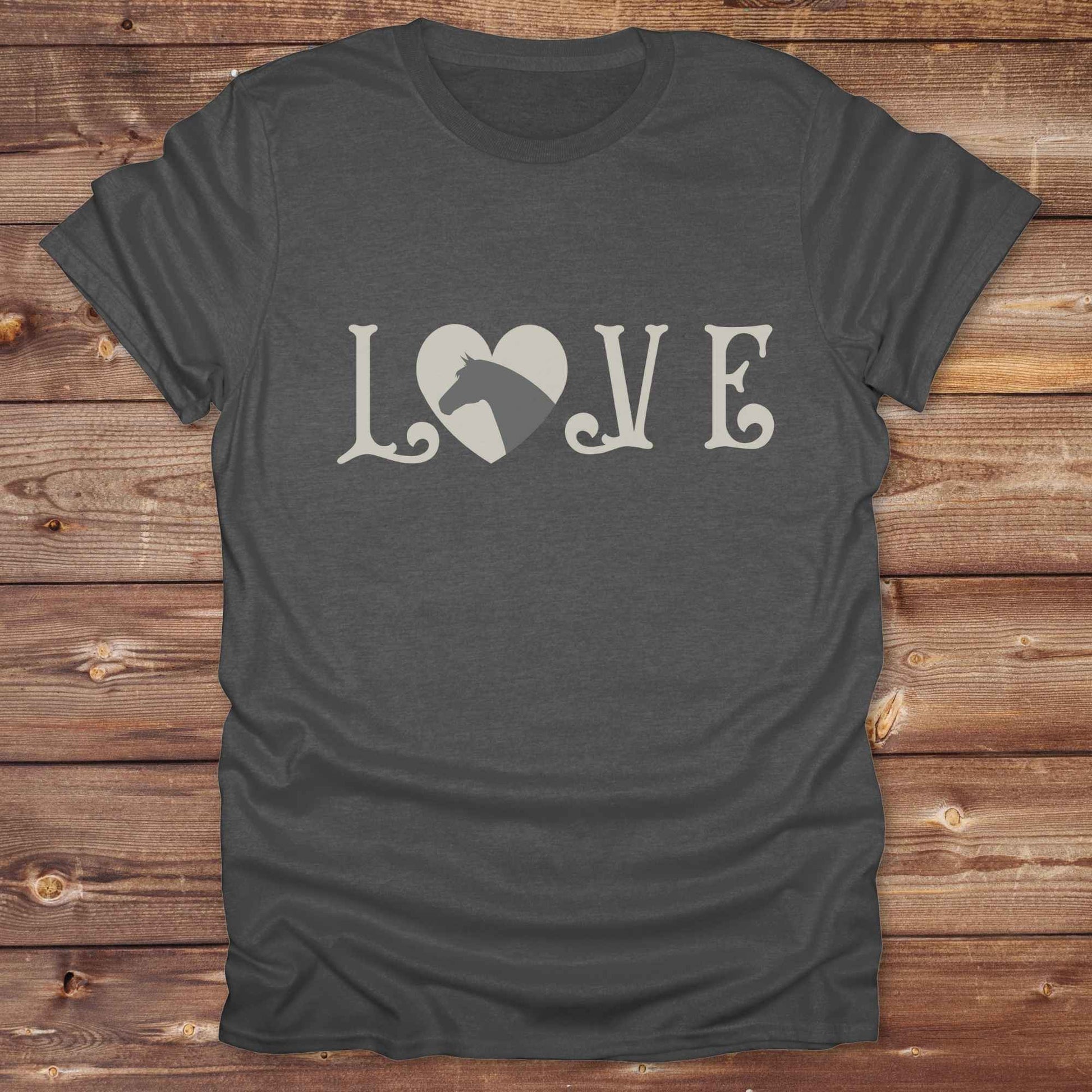 This Love Horses T-Shirt is the perfect expression of passion for horse lovers and cowgirls alike. With a unique heart-and-horse silhouette design and rustic western typography, it makes a thoughtful gift for birthdays, rodeo lovers, equestrians, and country women who live the cowboy lifestyle. The tee pairs well with denim, boots, and a bold cowgirl spirit. Whether for barn days, trail rides, or everyday western fashion, this shirt belongs in your rodeo ready wardrobe.