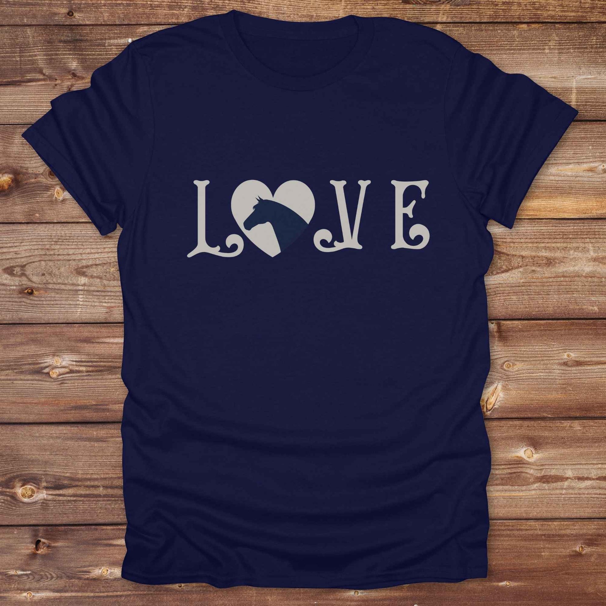 This Love Horses T-Shirt is the perfect expression of passion for horse lovers and cowgirls alike. With a unique heart-and-horse silhouette design and rustic western typography, it makes a thoughtful gift for birthdays, rodeo lovers, equestrians, and country women who live the cowboy lifestyle. The tee pairs well with denim, boots, and a bold cowgirl spirit. Whether for barn days, trail rides, or everyday western fashion, this shirt belongs in your rodeo ready wardrobe.