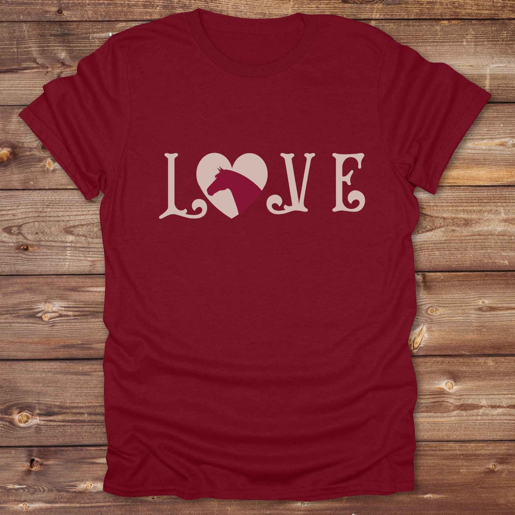 This Love Horses T-Shirt is the perfect expression of passion for horse lovers and cowgirls alike. With a unique heart-and-horse silhouette design and rustic western typography, it makes a thoughtful gift for birthdays, rodeo lovers, equestrians, and country women who live the cowboy lifestyle. The tee pairs well with denim, boots, and a bold cowgirl spirit. Whether for barn days, trail rides, or everyday western fashion, this shirt belongs in your rodeo ready wardrobe.
