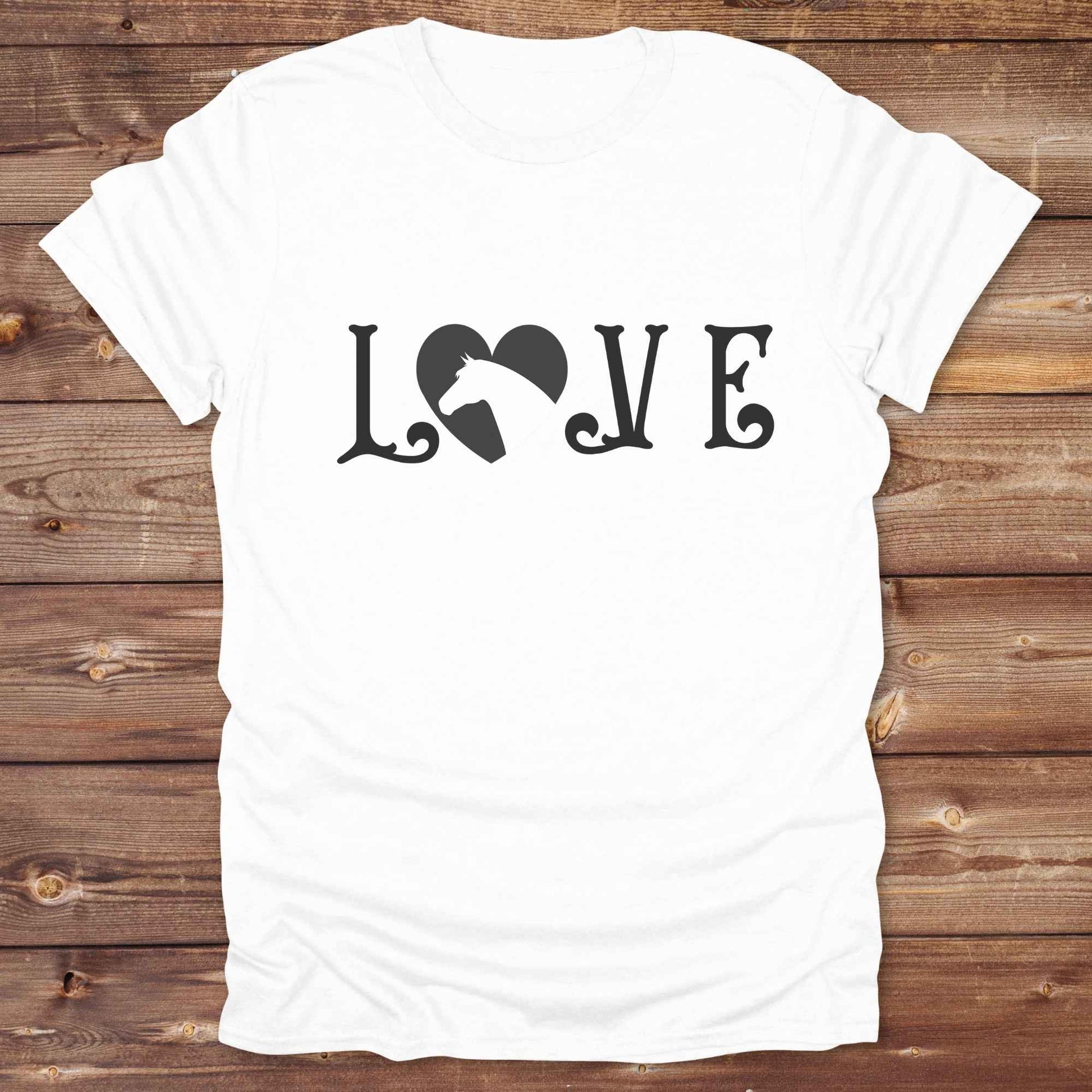 This Love Horses T-Shirt is the perfect expression of passion for horse lovers and cowgirls alike. With a unique heart-and-horse silhouette design and rustic western typography, it makes a thoughtful gift for birthdays, rodeo lovers, equestrians, and country women who live the cowboy lifestyle. The tee pairs well with denim, boots, and a bold cowgirl spirit. Whether for barn days, trail rides, or everyday western fashion, this shirt belongs in your rodeo ready wardrobe.