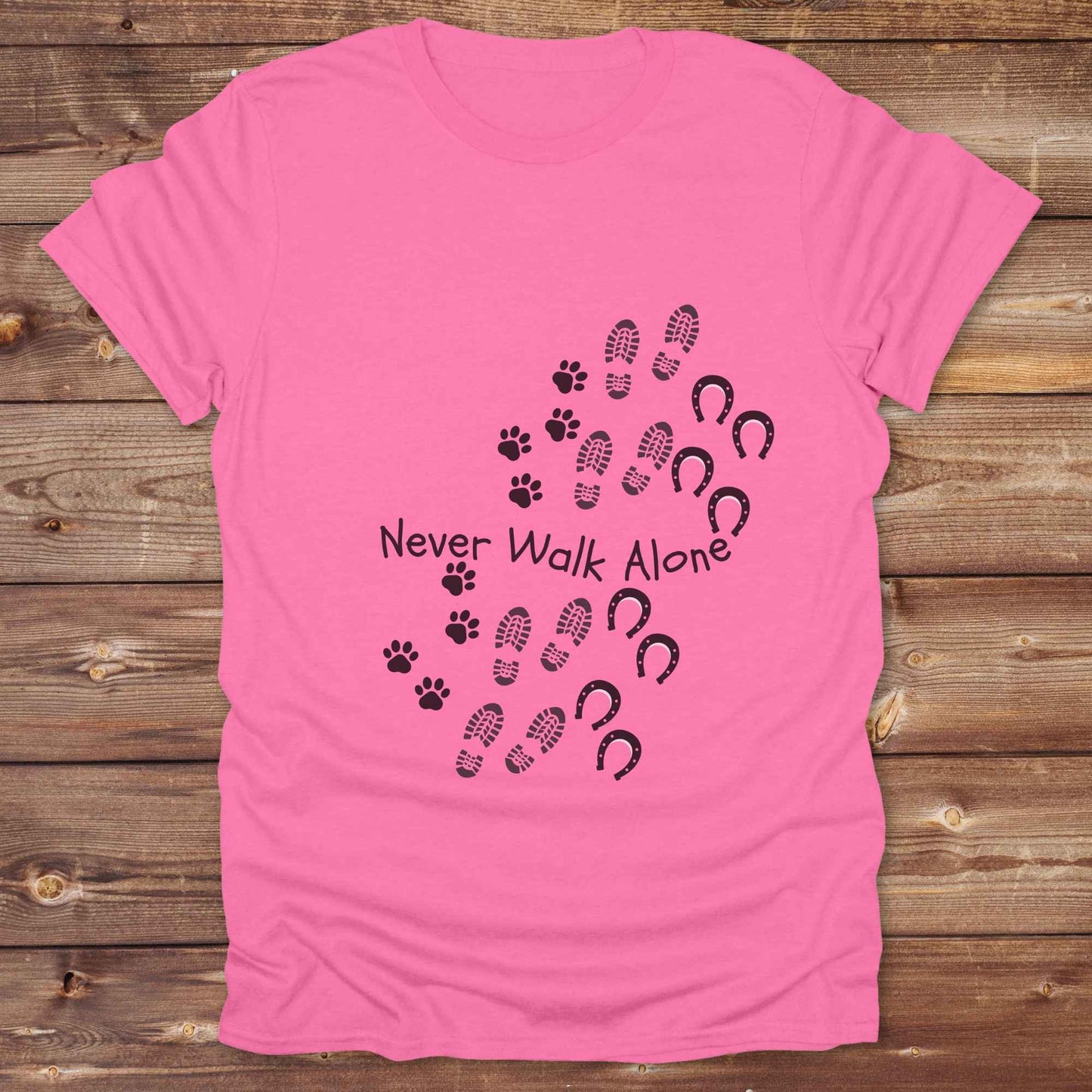 Celebrate the unbreakable bond between dogs, horses, and their human companions with this heartfelt "Never Walk Alone" western-style t-shirt. Featuring boot, paw, and hoof prints in a soft rustic print, this tee is perfect for cowgirls, dog moms, horse lovers, and equestrian trail riders alike. Whether you're walking through a ranch, riding across fields, or heading to the stables, this shirt is a perfect fit for your country lifestyle. Makes a thoughtful gift for birthdays, pet memorials, and western pet l