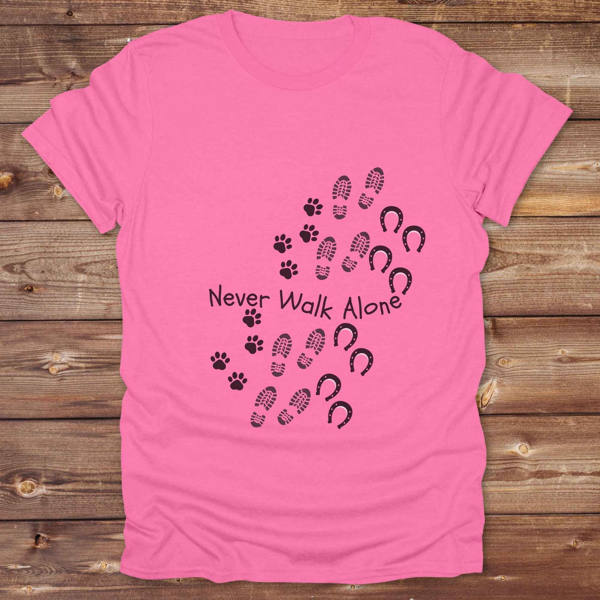 Celebrate the unbreakable bond between dogs, horses, and their human companions with this heartfelt "Never Walk Alone" western-style t-shirt. Featuring boot, paw, and hoof prints in a soft rustic print, this tee is perfect for cowgirls, dog moms, horse lovers, and equestrian trail riders alike. Whether you're walking through a ranch, riding across fields, or heading to the stables, this shirt is a perfect fit for your country lifestyle. Makes a thoughtful gift for birthdays, pet memorials, and western pet l