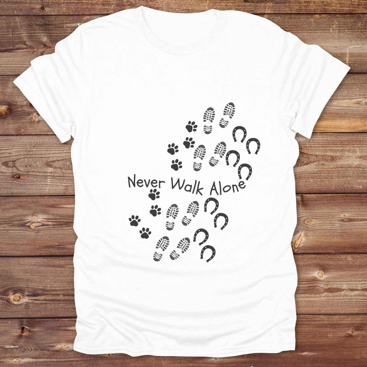 Celebrate the unbreakable bond between dogs, horses, and their human companions with this heartfelt "Never Walk Alone" western-style t-shirt. Featuring boot, paw, and hoof prints in a soft rustic print, this tee is perfect for cowgirls, dog moms, horse lovers, and equestrian trail riders alike. Whether you're walking through a ranch, riding across fields, or heading to the stables, this shirt is a perfect fit for your country lifestyle. Makes a thoughtful gift for birthdays, pet memorials, and western pet l