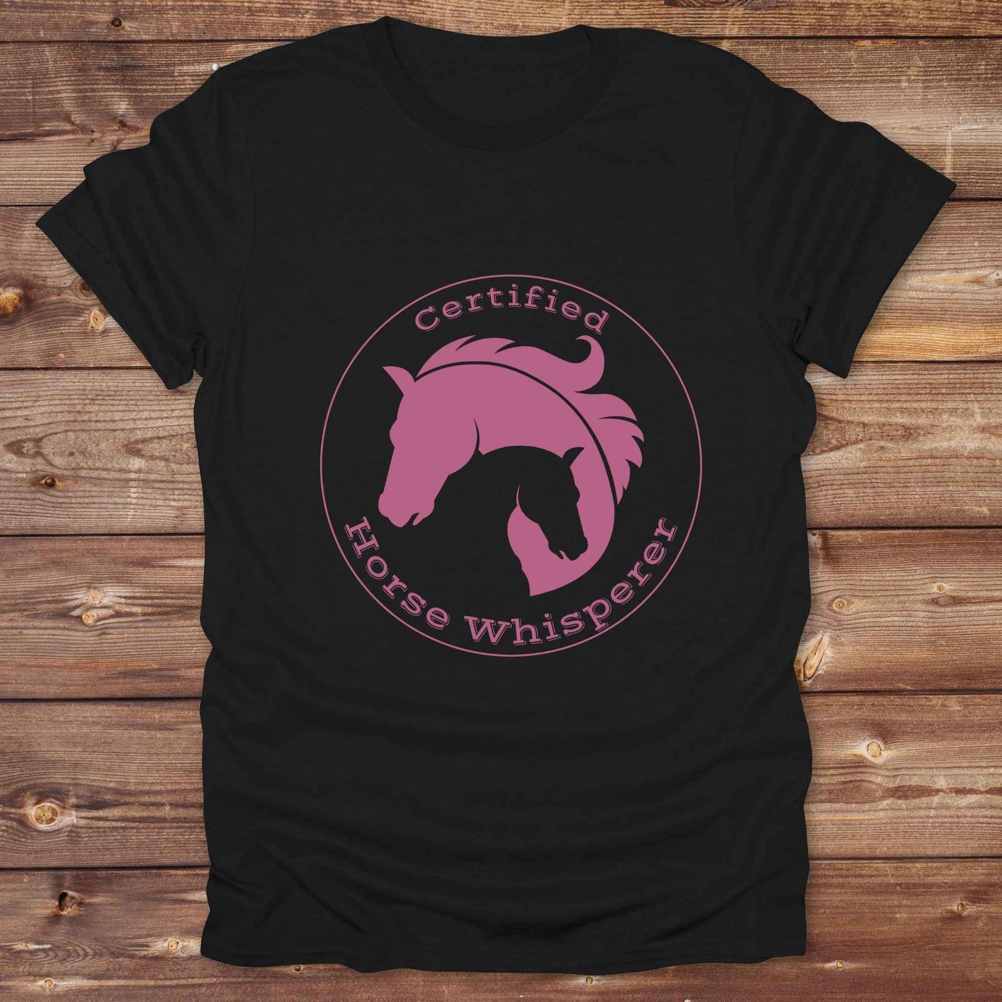 Certified Horse Whisperer T-Shirt is the perfect blend of rustic charm and equestrian elegance. Designed for horse lovers, cowboys, cowgirls, and trainers, this soft unisex graphic tee showcases a minimalist silhouette of two horses within a bold “Certified Horse Whisperer” typographic circle. It's a great gift for birthdays, rodeo fans, western riders, and anyone practicing natural horsemanship or quiet leadership. Conversation starter at the barn, rodeo, trail ride, or farmer’s market. Loved by riders.