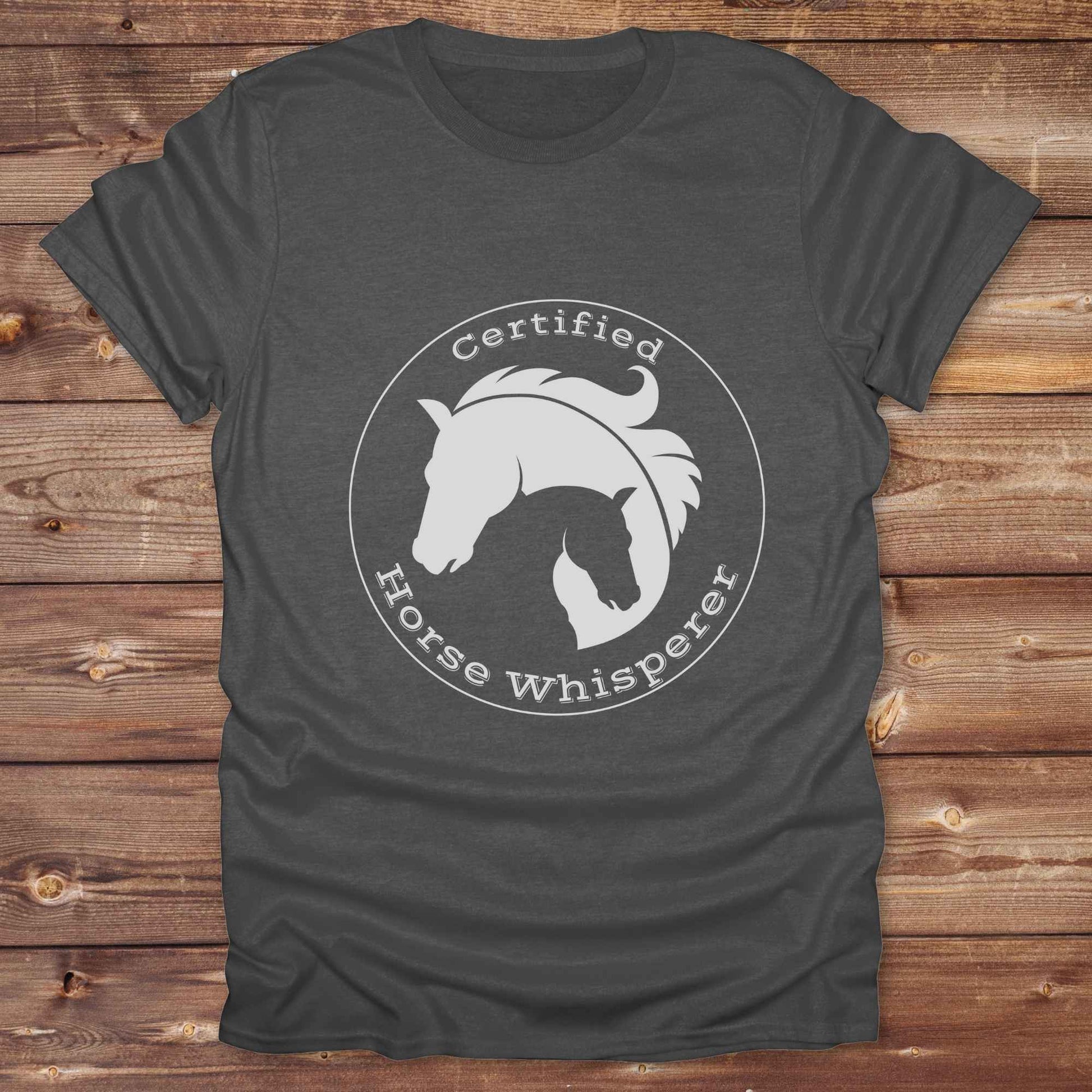 Certified Horse Whisperer T-Shirt is the perfect blend of rustic charm and equestrian elegance. Designed for horse lovers, cowboys, cowgirls, and trainers, this soft unisex graphic tee showcases a minimalist silhouette of two horses within a bold “Certified Horse Whisperer” typographic circle. It's a great gift for birthdays, rodeo fans, western riders, and anyone practicing natural horsemanship or quiet leadership. Conversation starter at the barn, rodeo, trail ride, or farmer’s market. Loved by riders.