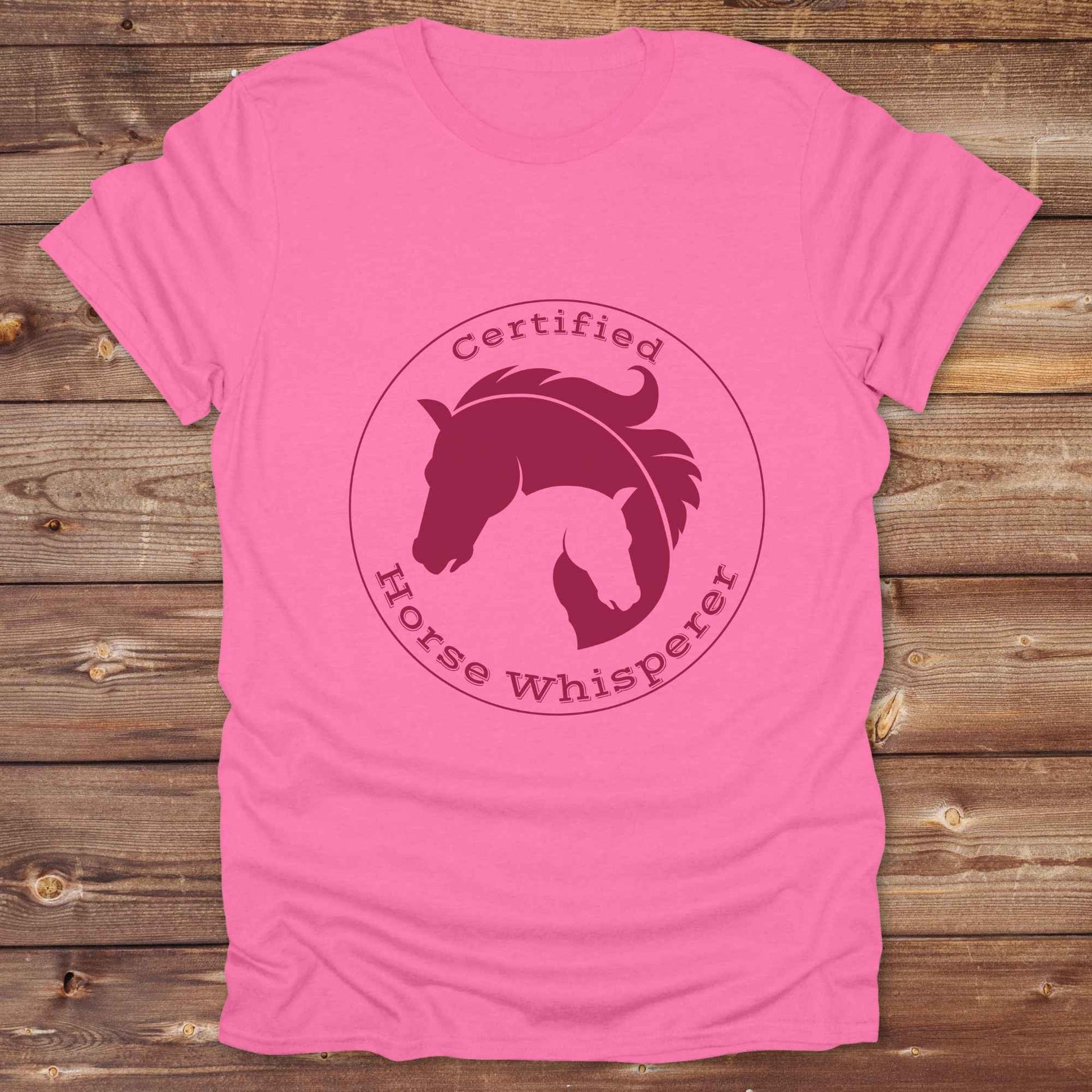 Certified Horse Whisperer T-Shirt is the perfect blend of rustic charm and equestrian elegance. Designed for horse lovers, cowboys, cowgirls, and trainers, this soft unisex graphic tee showcases a minimalist silhouette of two horses within a bold “Certified Horse Whisperer” typographic circle. It's a great gift for birthdays, rodeo fans, western riders, and anyone practicing natural horsemanship or quiet leadership. Conversation starter at the barn, rodeo, trail ride, or farmer’s market. Loved by riders.