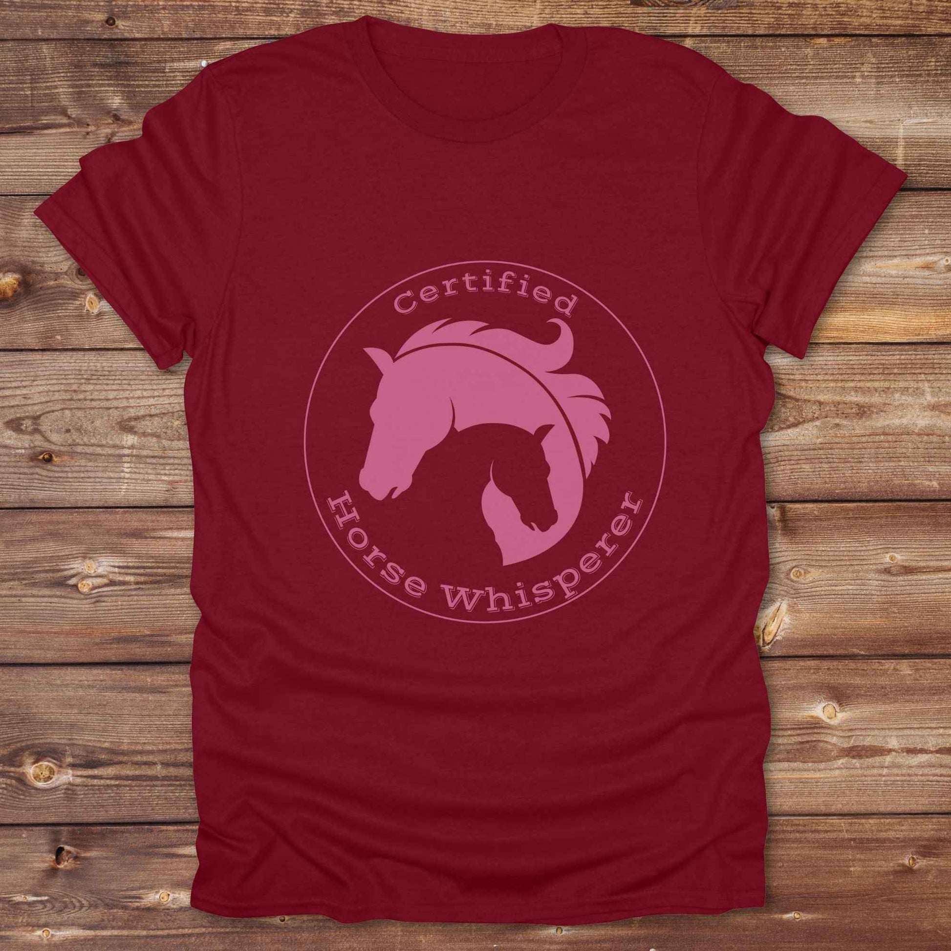 Certified Horse Whisperer T-Shirt is the perfect blend of rustic charm and equestrian elegance. Designed for horse lovers, cowboys, cowgirls, and trainers, this soft unisex graphic tee showcases a minimalist silhouette of two horses within a bold “Certified Horse Whisperer” typographic circle. It's a great gift for birthdays, rodeo fans, western riders, and anyone practicing natural horsemanship or quiet leadership. Conversation starter at the barn, rodeo, trail ride, or farmer’s market. Loved by riders.