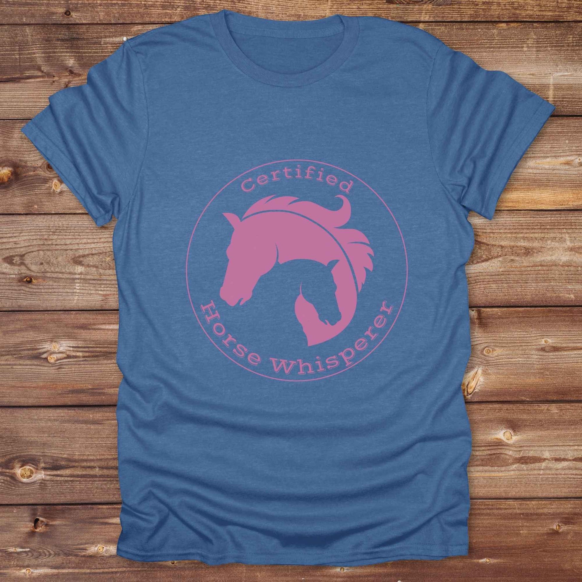 Certified Horse Whisperer T-Shirt is the perfect blend of rustic charm and equestrian elegance. Designed for horse lovers, cowboys, cowgirls, and trainers, this soft unisex graphic tee showcases a minimalist silhouette of two horses within a bold “Certified Horse Whisperer” typographic circle. It's a great gift for birthdays, rodeo fans, western riders, and anyone practicing natural horsemanship or quiet leadership. Conversation starter at the barn, rodeo, trail ride, or farmer’s market. Loved by riders.