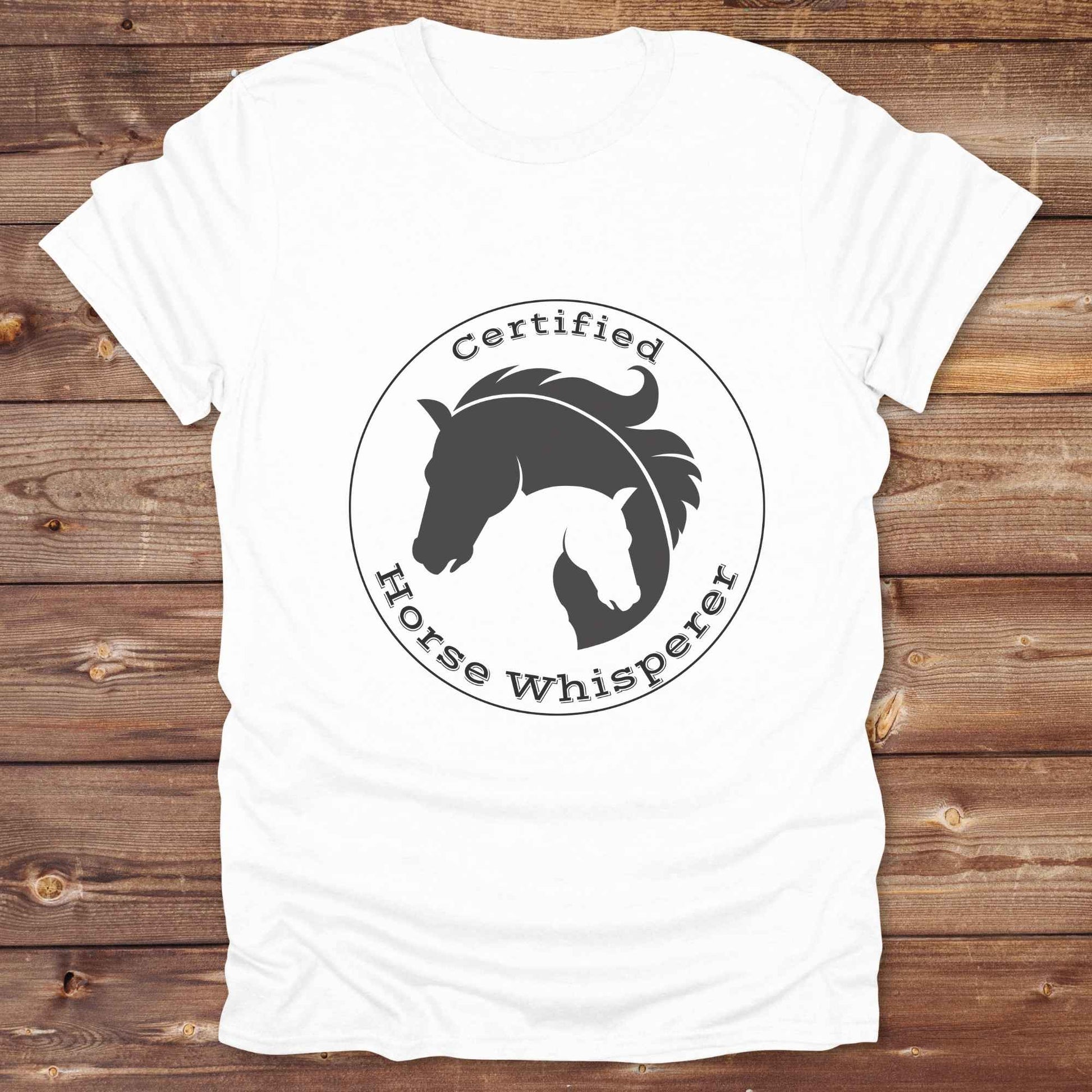 Certified Horse Whisperer T-Shirt is the perfect blend of rustic charm and equestrian elegance. Designed for horse lovers, cowboys, cowgirls, and trainers, this soft unisex graphic tee showcases a minimalist silhouette of two horses within a bold “Certified Horse Whisperer” typographic circle. It's a great gift for birthdays, rodeo fans, western riders, and anyone practicing natural horsemanship or quiet leadership. Conversation starter at the barn, rodeo, trail ride, or farmer’s market. Loved by riders.