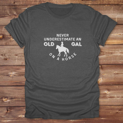 Fun western t-shirt for horse lovers and cowgirls. Western cowgirl graphic tee with horse design. Cowboy humor t-shirt for rodeo and country lovers. Horse lover funny t-shirt with western theme. Country style horse graphic tee for cowboys and cowgirls. Retro style funny western shirt for equestrians. Cute and funny country shirt with horse print. Southern cowgirl funny quote shirt for horse lovers. Never underestimate an old gal on a horse.