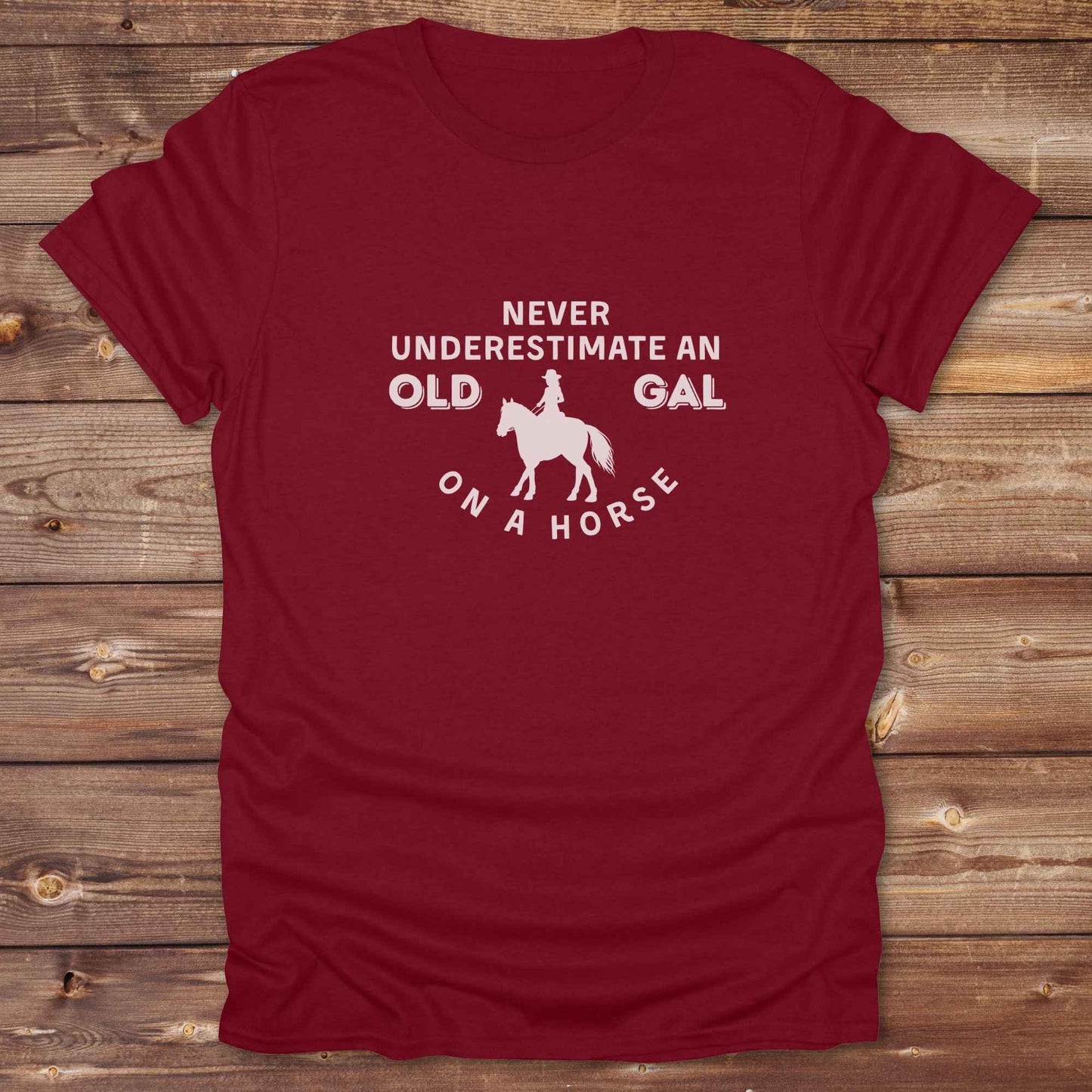 Fun western t-shirt for horse lovers and cowgirls. Western cowgirl graphic tee with horse design. Cowboy humor t-shirt for rodeo and country lovers. Horse lover funny t-shirt with western theme. Country style horse graphic tee for cowboys and cowgirls. Retro style funny western shirt for equestrians. Cute and funny country shirt with horse print. Southern cowgirl funny quote shirt for horse lovers. Never underestimate an old gal on a horse.