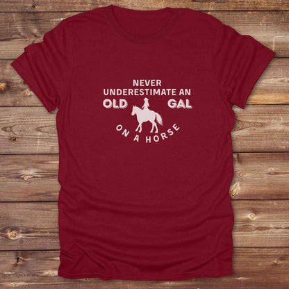 Fun western t-shirt for horse lovers and cowgirls. Western cowgirl graphic tee with horse design. Cowboy humor t-shirt for rodeo and country lovers. Horse lover funny t-shirt with western theme. Country style horse graphic tee for cowboys and cowgirls. Retro style funny western shirt for equestrians. Cute and funny country shirt with horse print. Southern cowgirl funny quote shirt for horse lovers. Never underestimate an old gal on a horse.