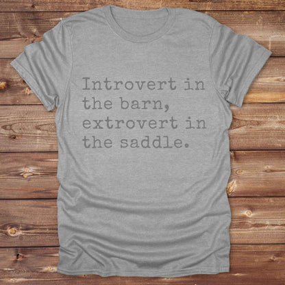 “Introvert in the Barn, Extrovert in the Saddle” t-shirt is the ultimate tee for horse lovers, cowgirls, and western introverts. Whether you're quietly mucking stalls or stealing the show in the arena. made for equestrian souls who ride louder than they talk. Designed with comfort in mind, this western quote shirt is perfect for rodeo nights, barn hangs, or gifting a fellow horse girl.