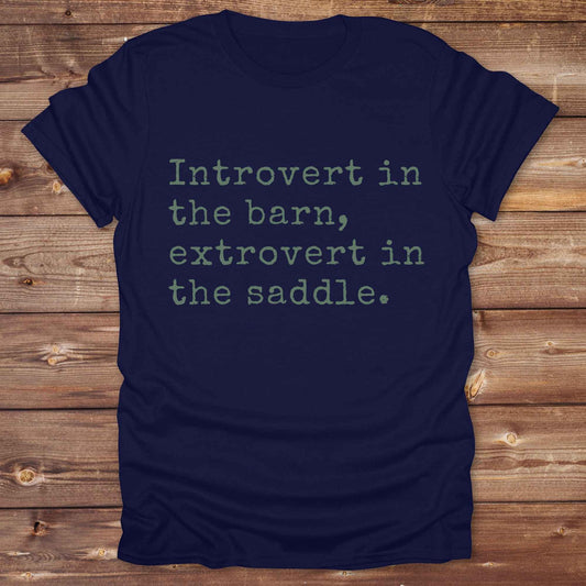 “Introvert in the Barn, Extrovert in the Saddle” t-shirt is the ultimate tee for horse lovers, cowgirls, and western introverts. Whether you're quietly mucking stalls or stealing the show in the arena. made for equestrian souls who ride louder than they talk. Designed with comfort in mind, this western quote shirt is perfect for rodeo nights, barn hangs, or gifting a fellow horse girl.