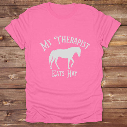 “My Therapist Eats Hay” t-shirt is the perfect mix of humor and horse lover pride, made for cowgirls, cowboys, and western enthusiasts alike. Featuring a bold horse silhouette and vintage western font, it’s ideal for barn days, rodeo nights, or gifting to someone who finds peace in the pasture. Great for birthdays, country events, or just repping your equine therapist with style. Whether you ride for fun or sanity, this western tee keeps the cowboy spirit alive with every wear.