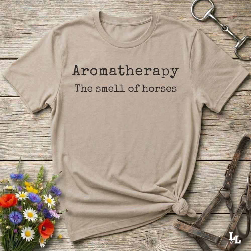beige This "Aromatherapy: The Smell of Horses" t-shirt is perfect for cowgirls, horse moms, and equestrian fans who adore the unmistakable barn scent of saddles, hay, and horses. Designed with rustic charm and equine humor, it makes an ideal gift for western lifestyle lovers, riders, or anyone who finds peace in the smell of a stable. Whether it’s for rodeos, barn events, or lounging in the pasture, this tee says what every true horse lover knows.