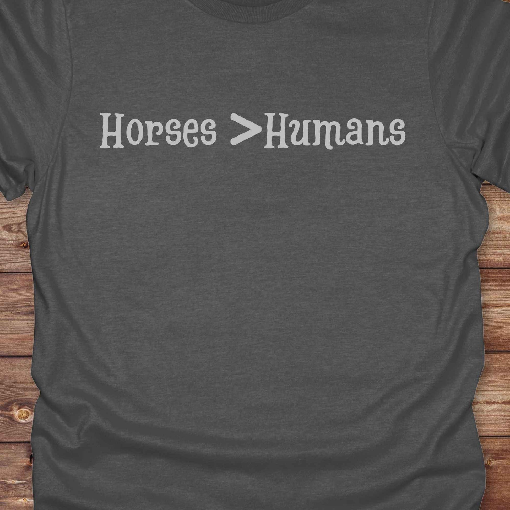 Show off your equestrian spirit with our “Horses > Humans” western t-shirt — made for horse lovers with a sense of humor. This minimal black design says it all: horses are better than people, period. Perfect for cowgirls, cowboys, equestrians, rodeo fans, and sarcastic ranch folk who know where their loyalty lies. Whether you're gifting it to a horse girl or repping it at a rodeo, this tee delivers comfort, country attitude, and all the sass. 